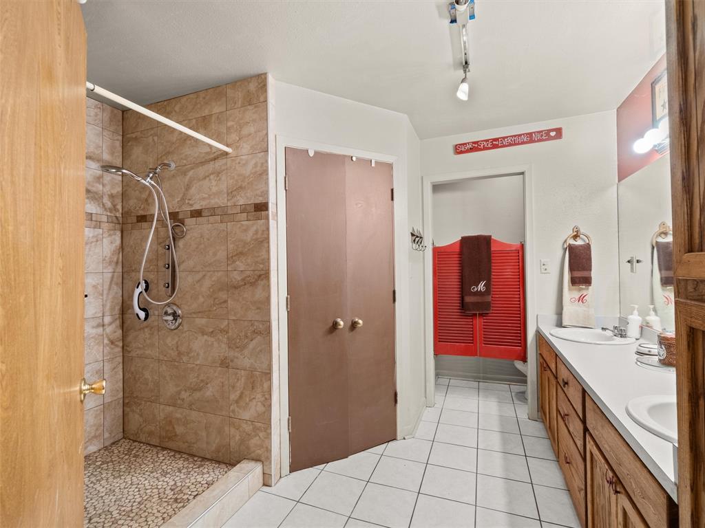 4608 Highway 154 Gilmer, TX 75644 - Photo 21 of 25 a spacious bathroom with a shower and a sink