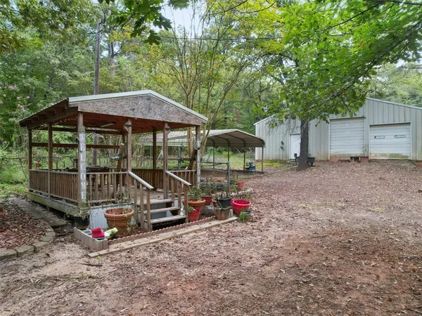 a view of a small house with wooden fence
