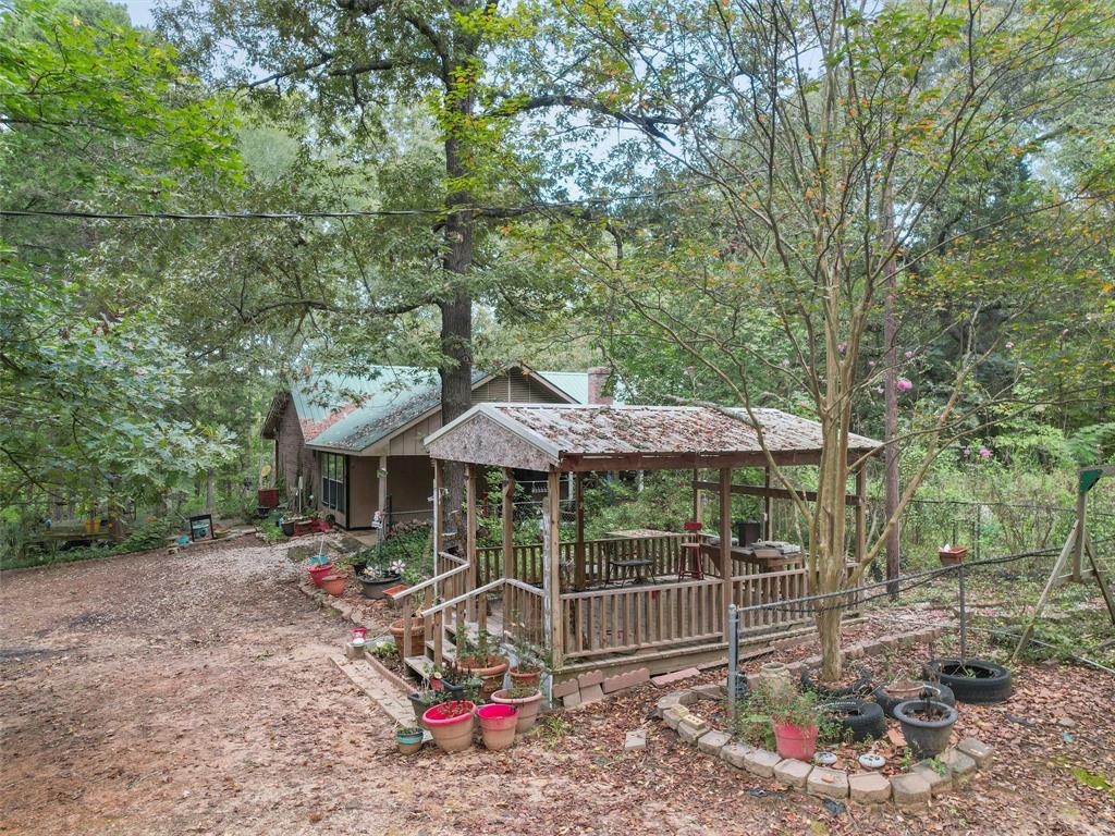 4608 Highway 154 Gilmer, TX 75644 - Photo 9 of 25 a view of a patio with a table and chairs under an umbrella