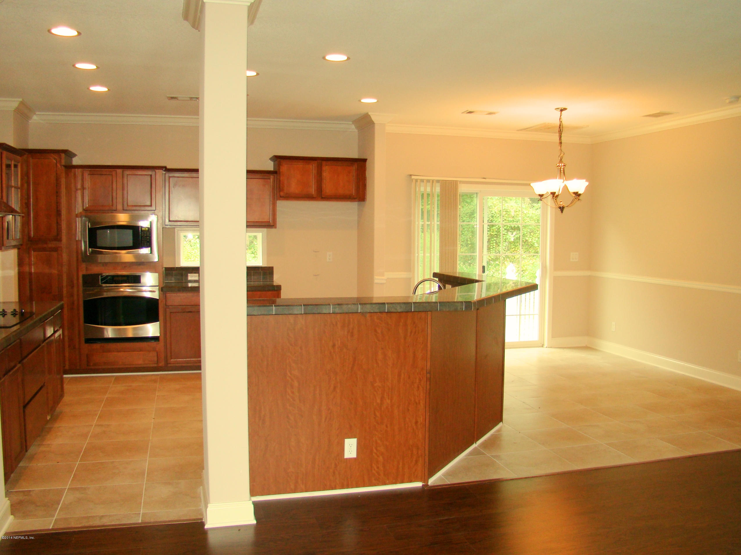 1716 Mccaul Road Jacksonville, FL 32220 - Photo 11 of 25 a kitchen with stainless steel appliances a refrigerator and a kitchen island