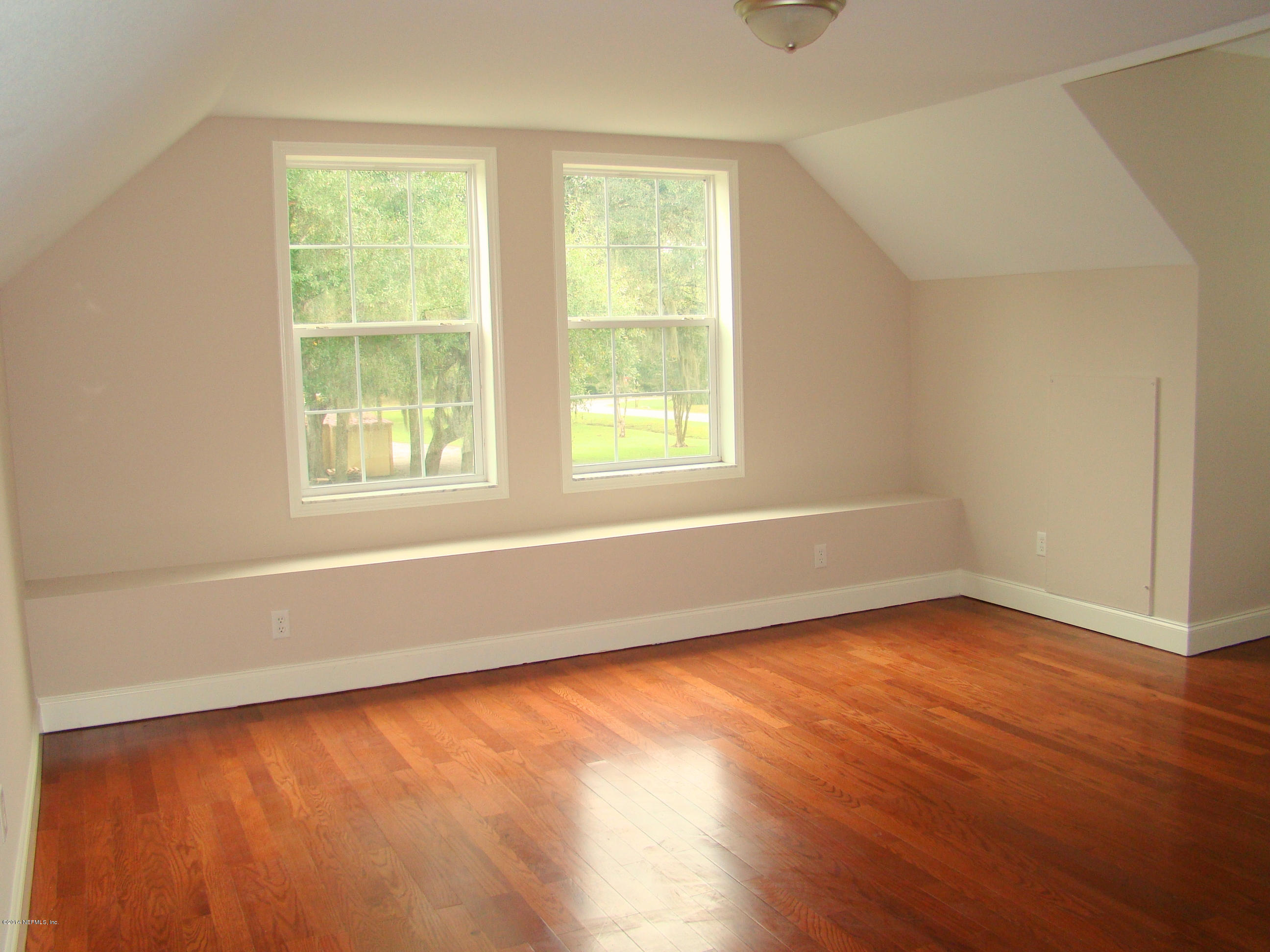 1716 Mccaul Road Jacksonville, FL 32220 - Photo 14 of 25 an empty room with wooden floor and windows