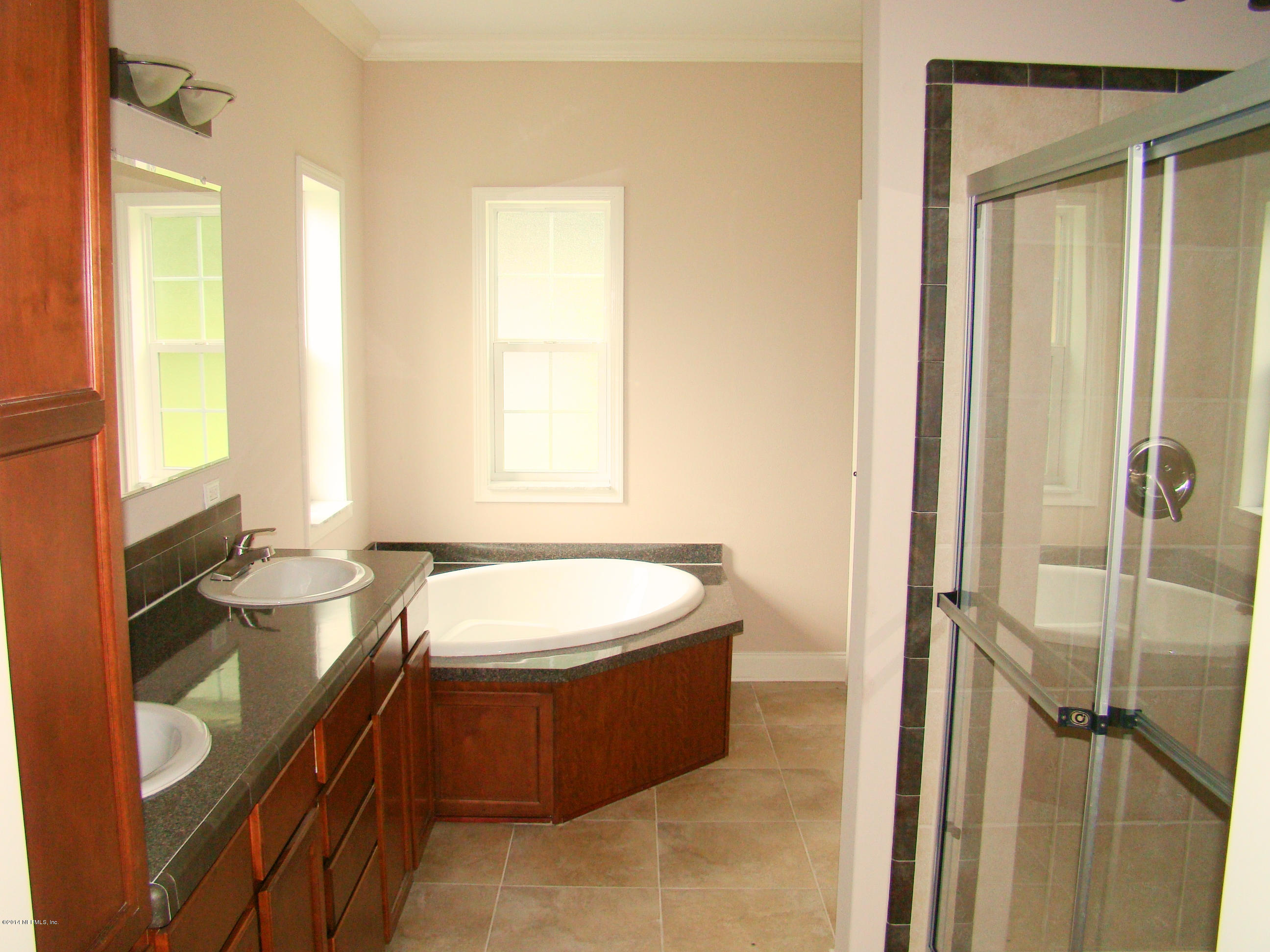 1716 Mccaul Road Jacksonville, FL 32220 - Photo 16 of 25 a bathroom with a double vanity sink toilet mirror and tub