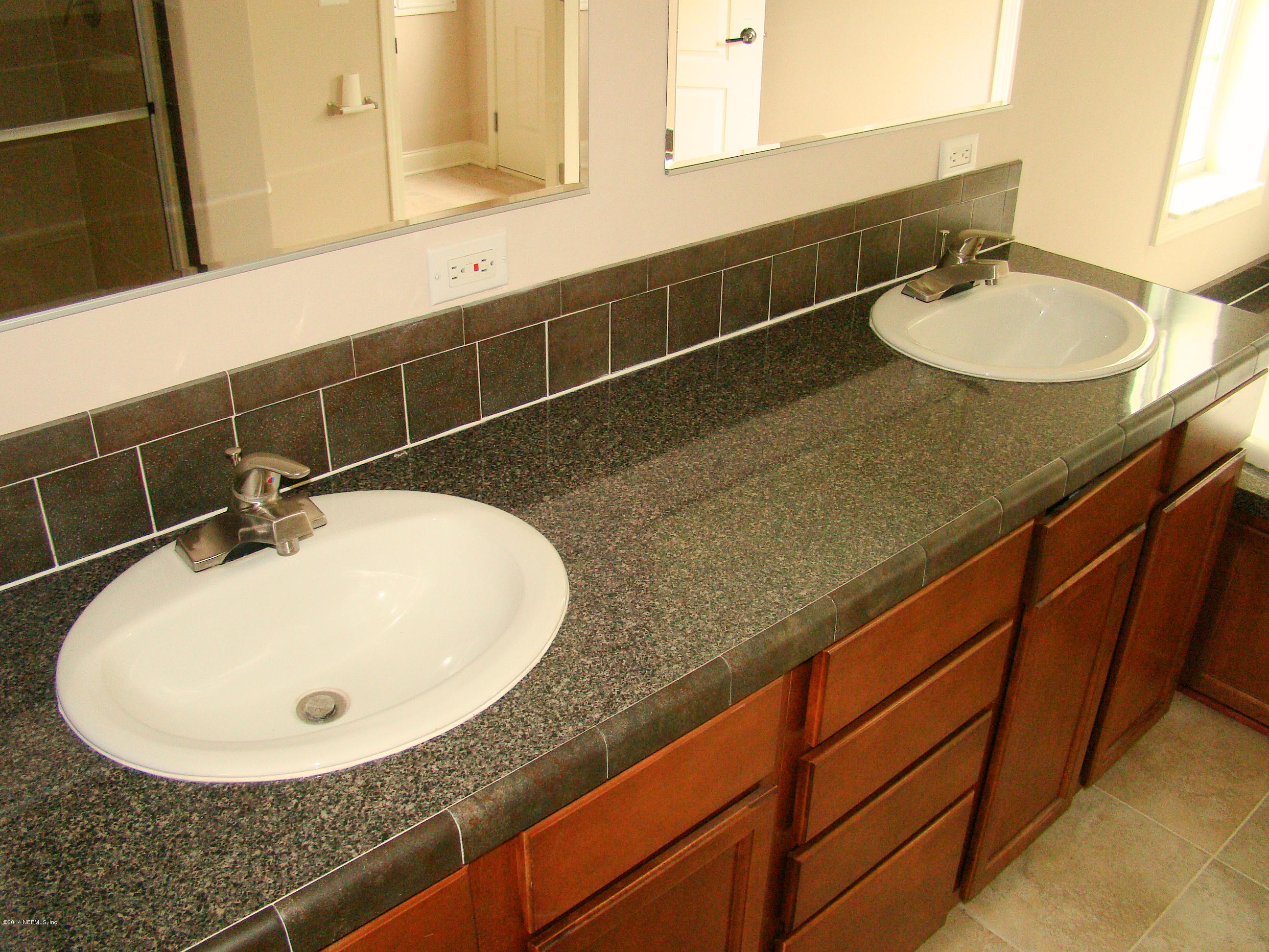 1716 Mccaul Road Jacksonville, FL 32220 - Photo 17 of 25 a bathroom with a sink and mirror