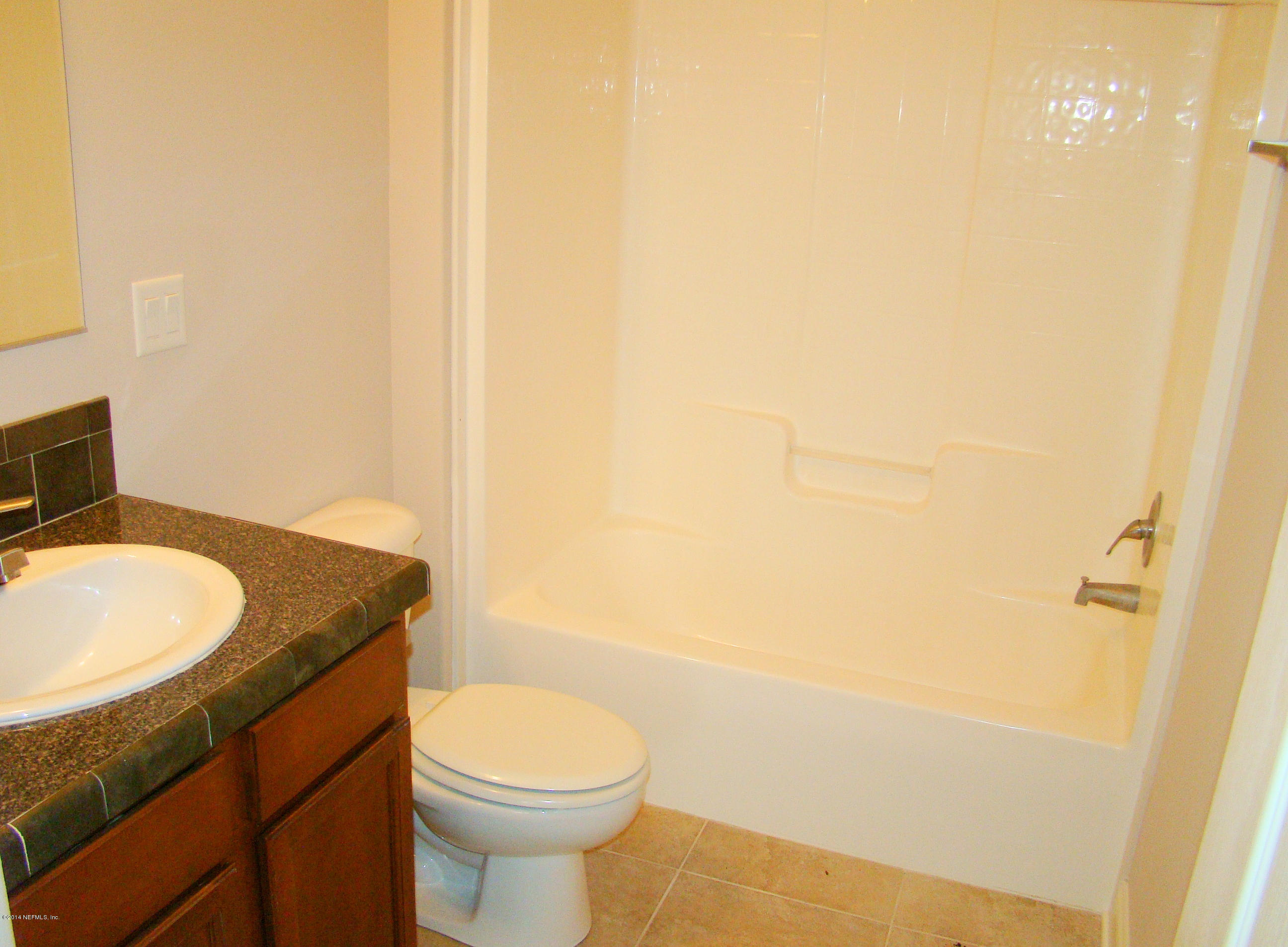 1716 Mccaul Road Jacksonville, FL 32220 - Photo 22 of 25 a bathroom with a granite countertop toilet and a sink