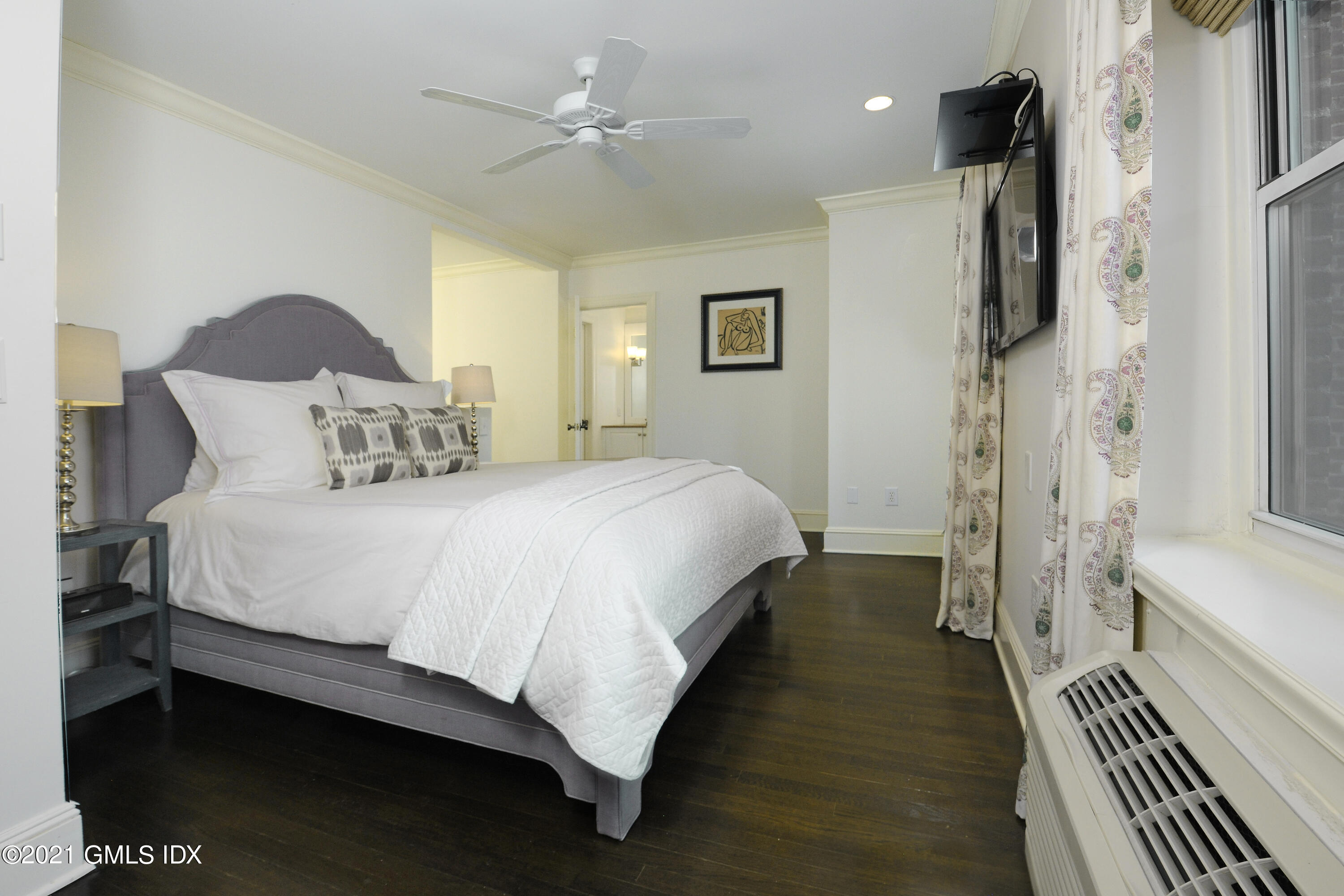 25 West Elm Street, Unit 47 Greenwich, CT 06830 - Photo 11 of 18 a spacious bedroom with a bed and a chandelier