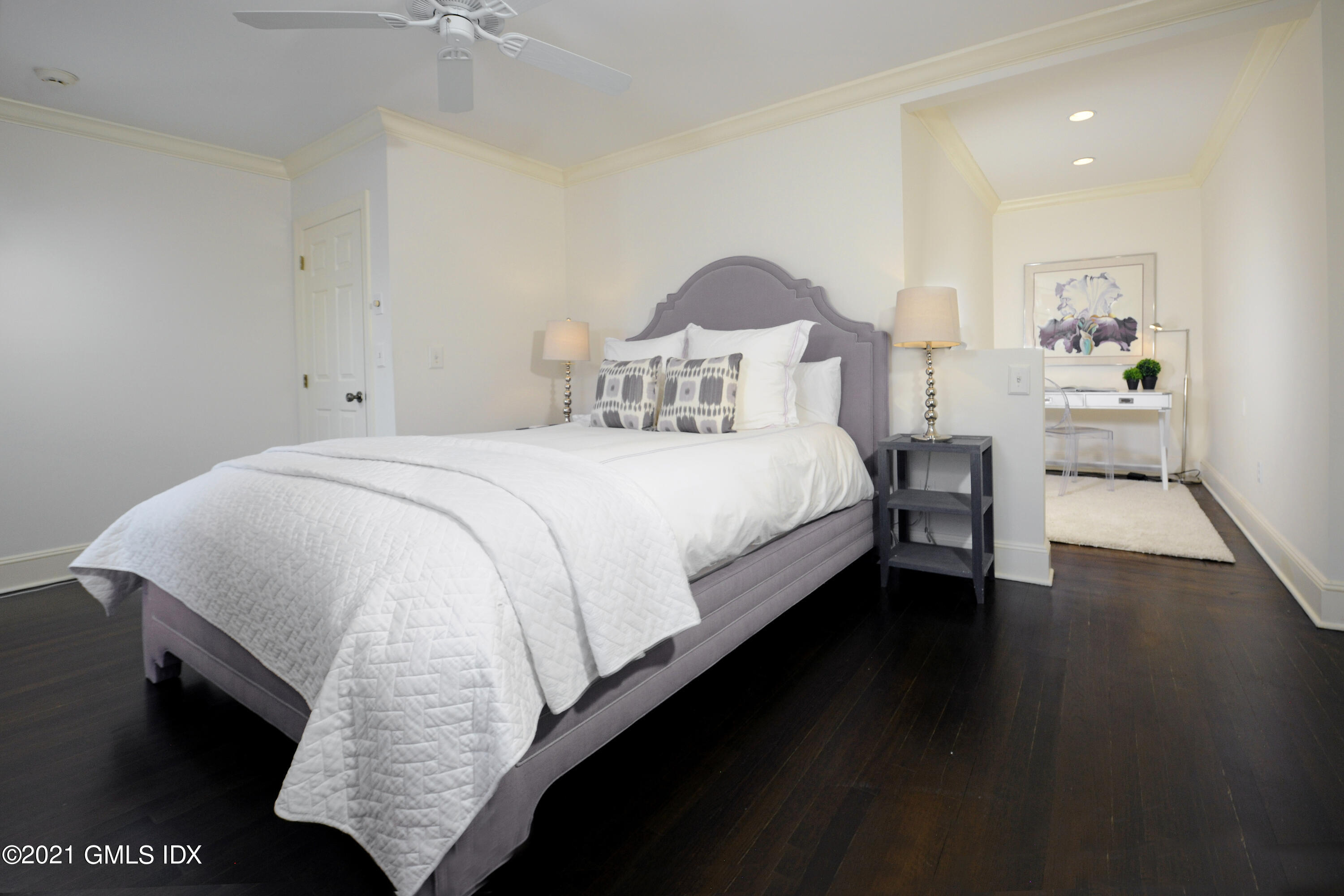 25 West Elm Street, Unit 47 Greenwich, CT 06830 - Photo 12 of 18 a bedroom with a bed and wooden floor