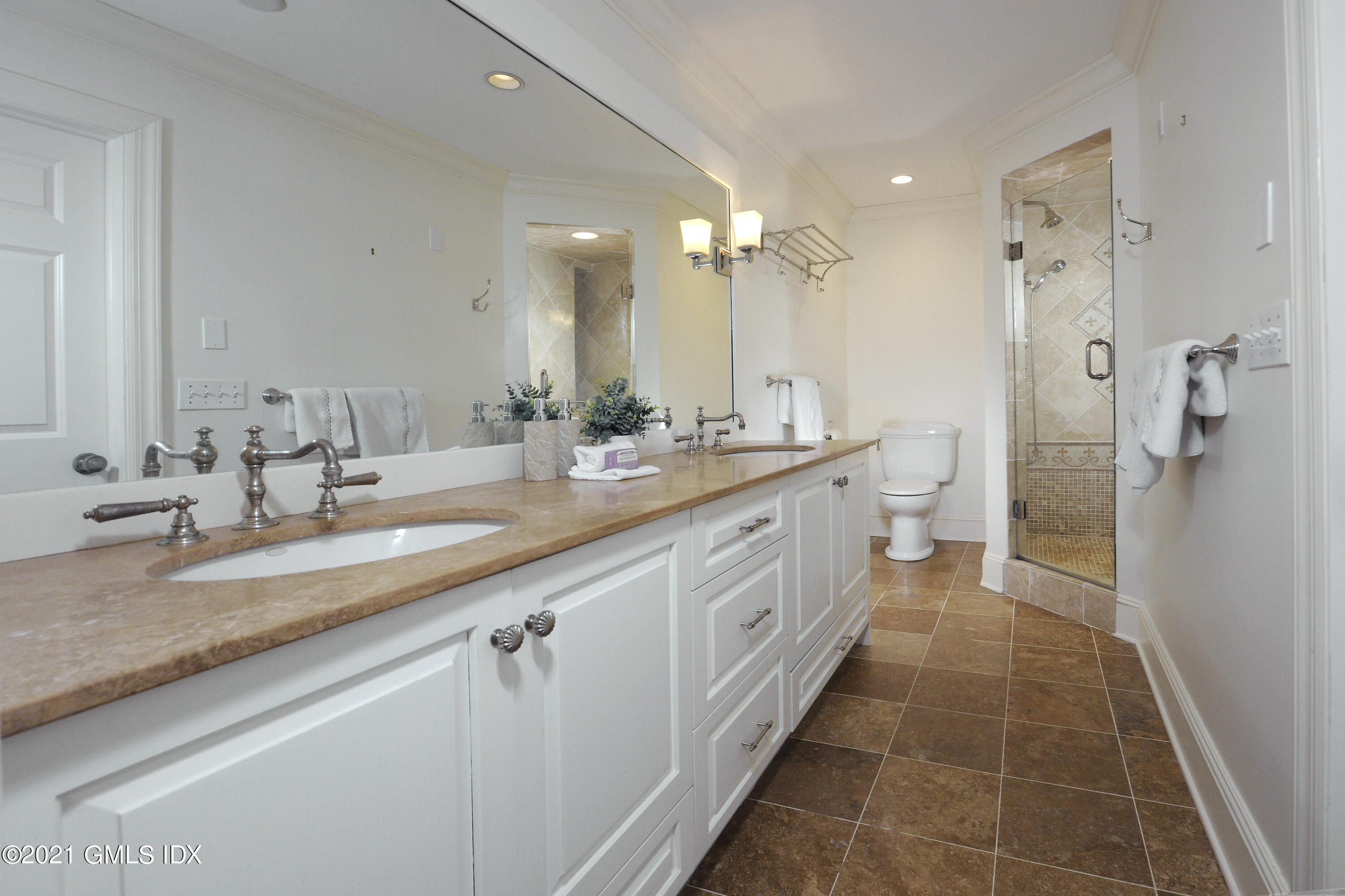 25 West Elm Street, Unit 47 Greenwich, CT 06830 - Photo 14 of 18 a spacious bathroom with a double vanity sink a mirror and a shower
