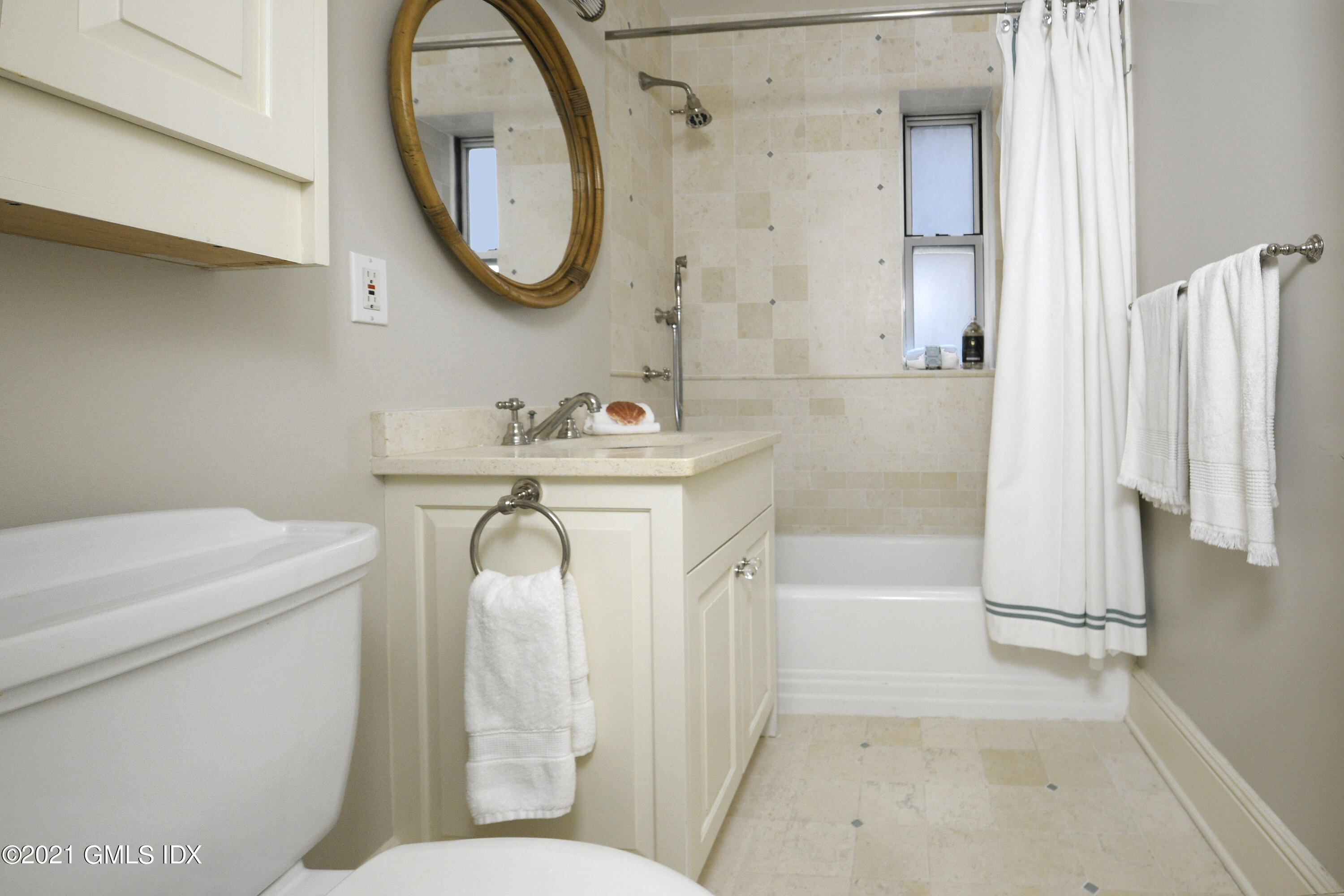 25 West Elm Street, Unit 47 Greenwich, CT 06830 - Photo 16 of 18 a bathroom with a sink a toilet and a mirror