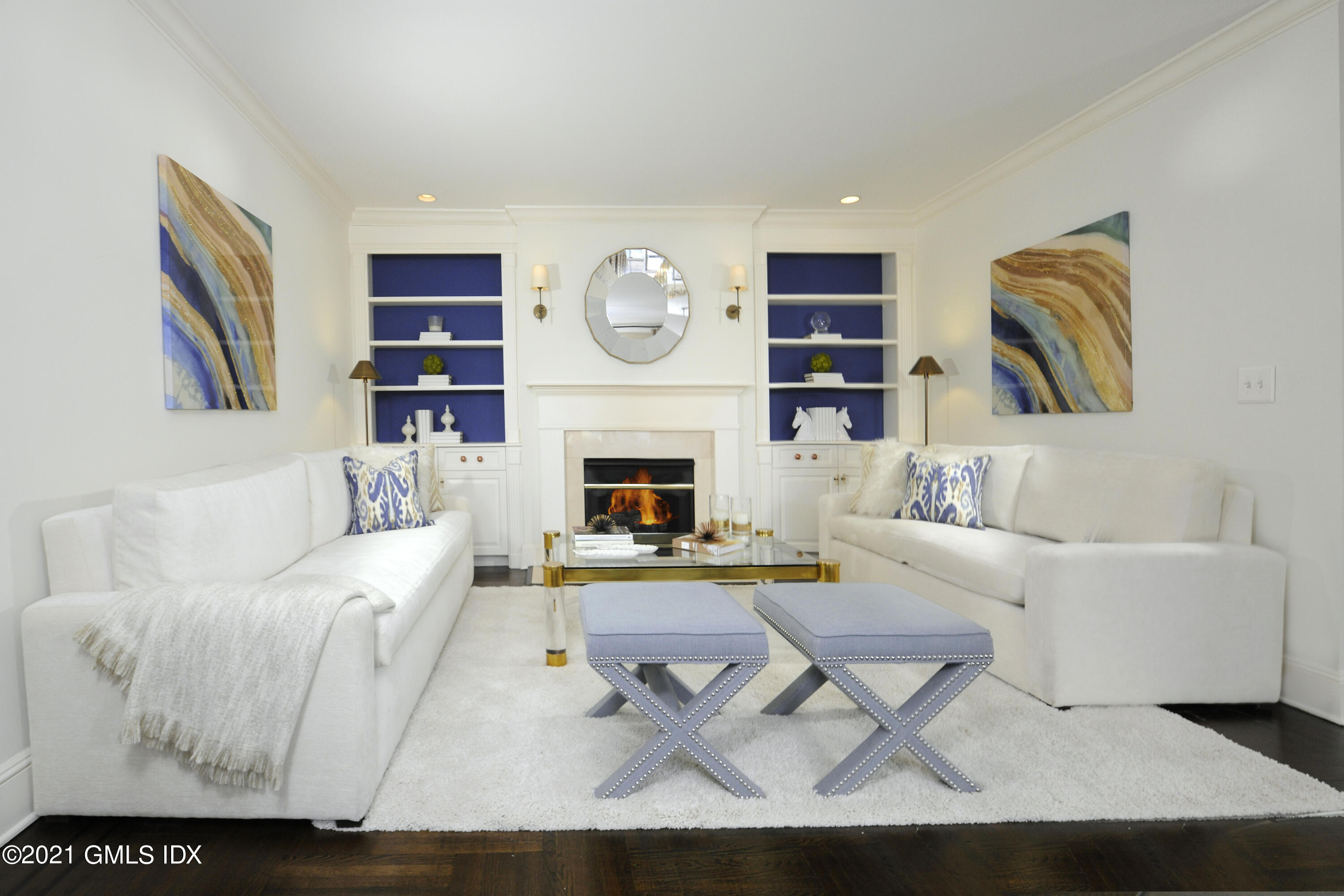 25 West Elm Street, Unit 47 Greenwich, CT 06830 - Photo 4 of 18 a living room with furniture a fireplace and a large mirror
