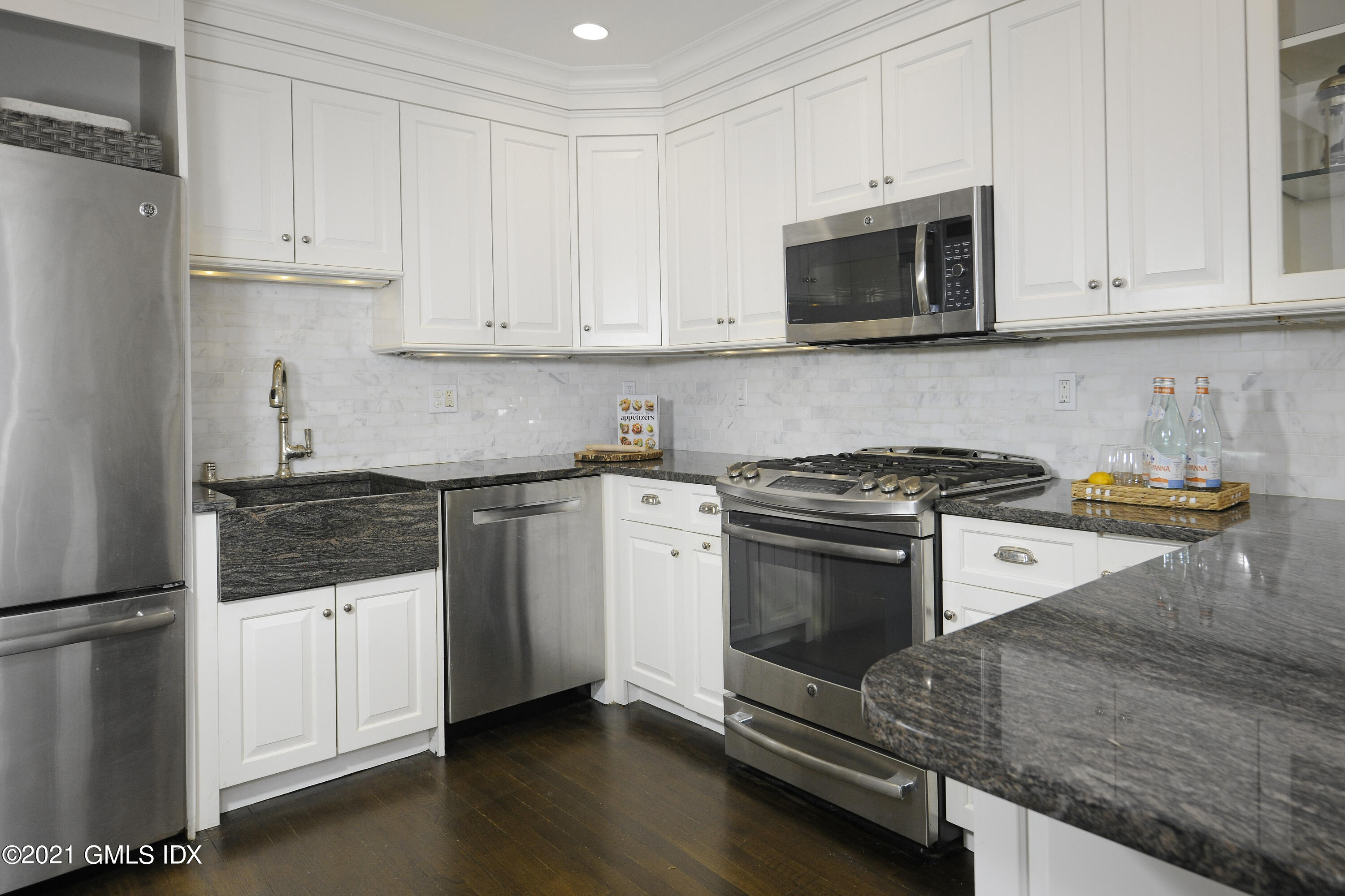 25 West Elm Street, Unit 47 Greenwich, CT 06830 - Photo 9 of 18 a kitchen with granite countertop white cabinets and stainless steel appliances