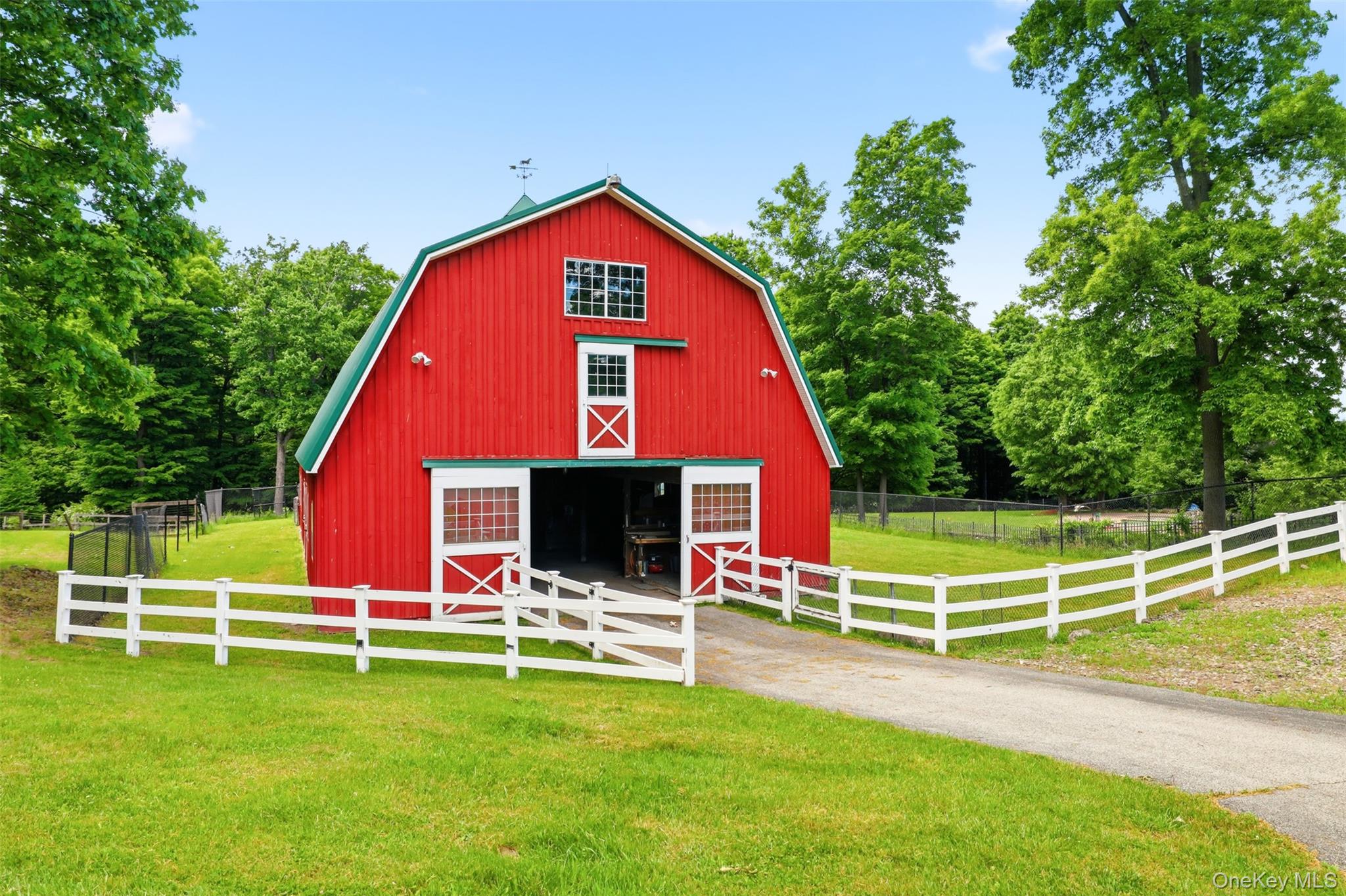 95 Judson Road Montgomery, NY 12549 - Photo 41 of 50 Equestrian enthusiasts will appreciate the substantial two-story barn currently configured for five horses with room for expansion, along with a massive hay loft, multiple fenced paddocks, and supporting outbuildings. A separate mechanic's garage and workshop sits farther down the drive, providing privacy and flexibility for hobbyists, collectors, or business pursuits.