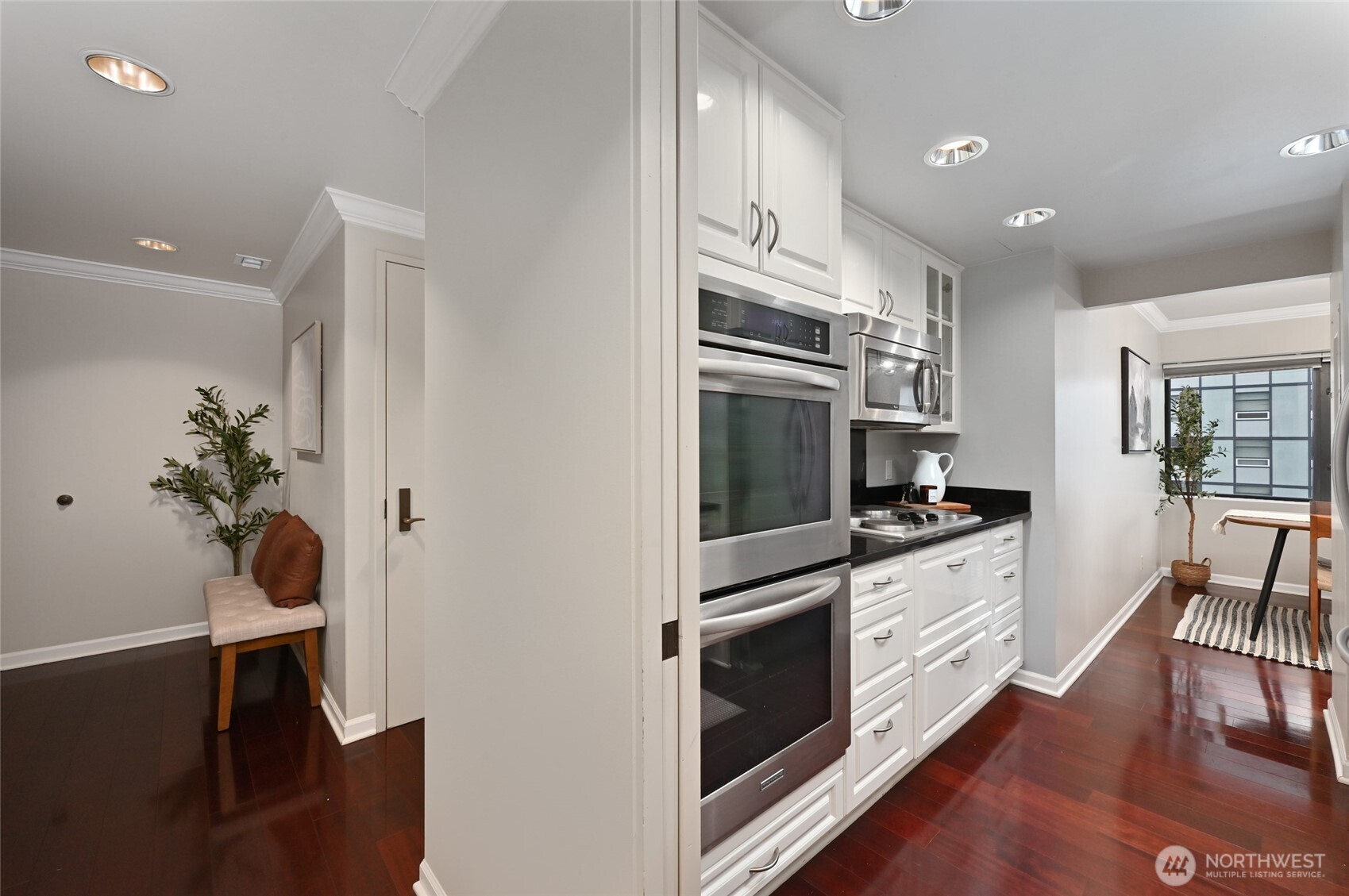1301 Spring Street, Unit 16C Seattle, WA 98104 - Photo 11 of 33 a kitchen with stainless steel appliances a stove refrigerator sink and cabinets