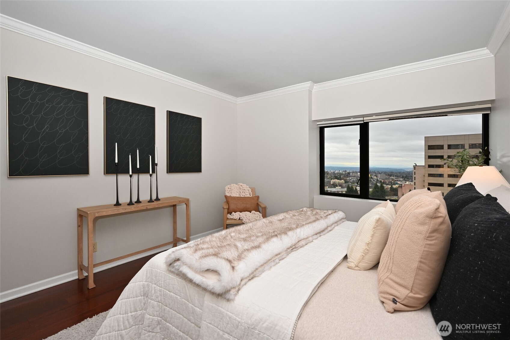 1301 Spring Street, Unit 16C Seattle, WA 98104 - Photo 13 of 33 a bedroom with a large bed and a flat tv screen on dresser