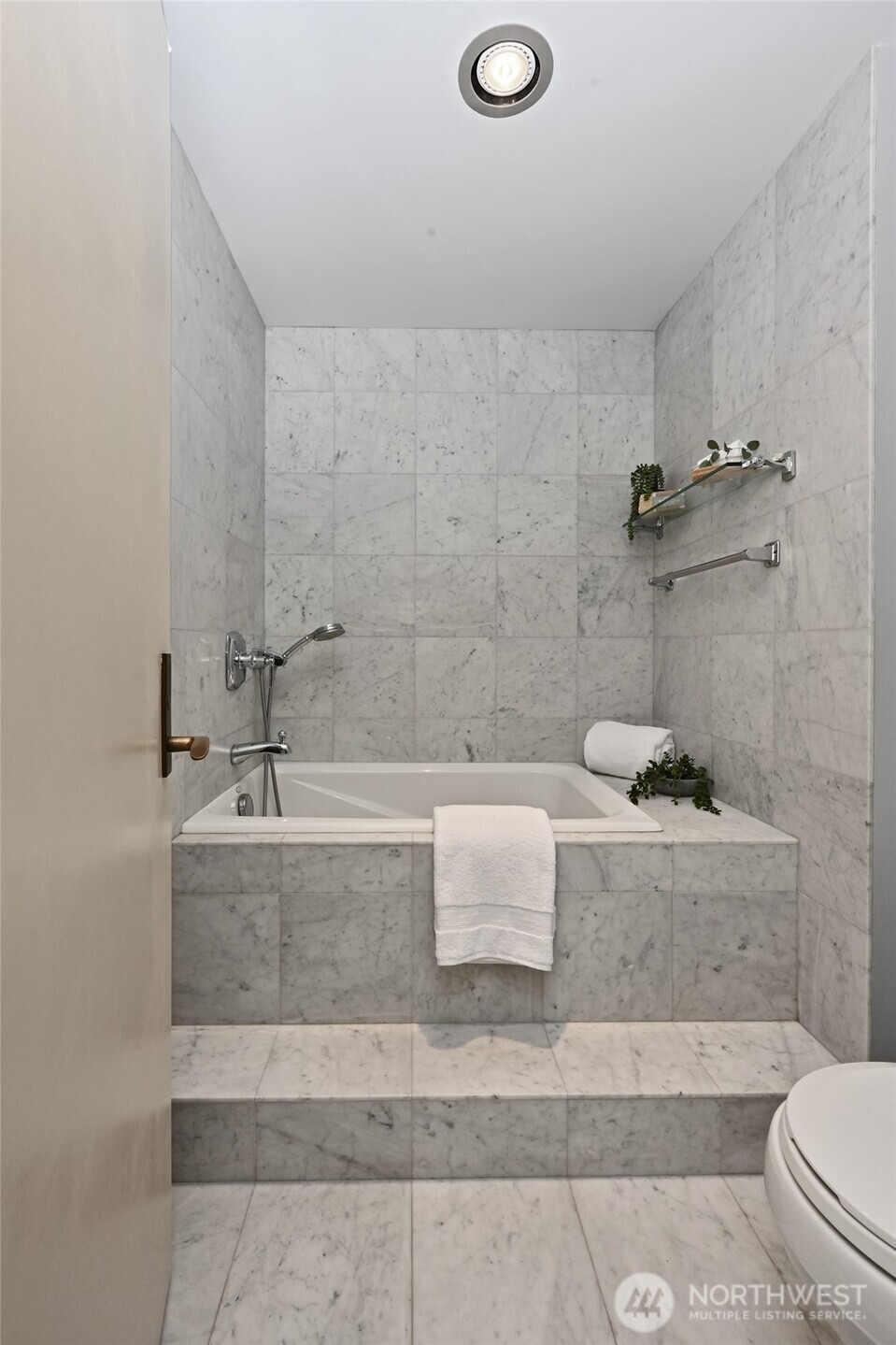 1301 Spring Street, Unit 16C Seattle, WA 98104 - Photo 15 of 33 a bathroom with a bathtub and toilet