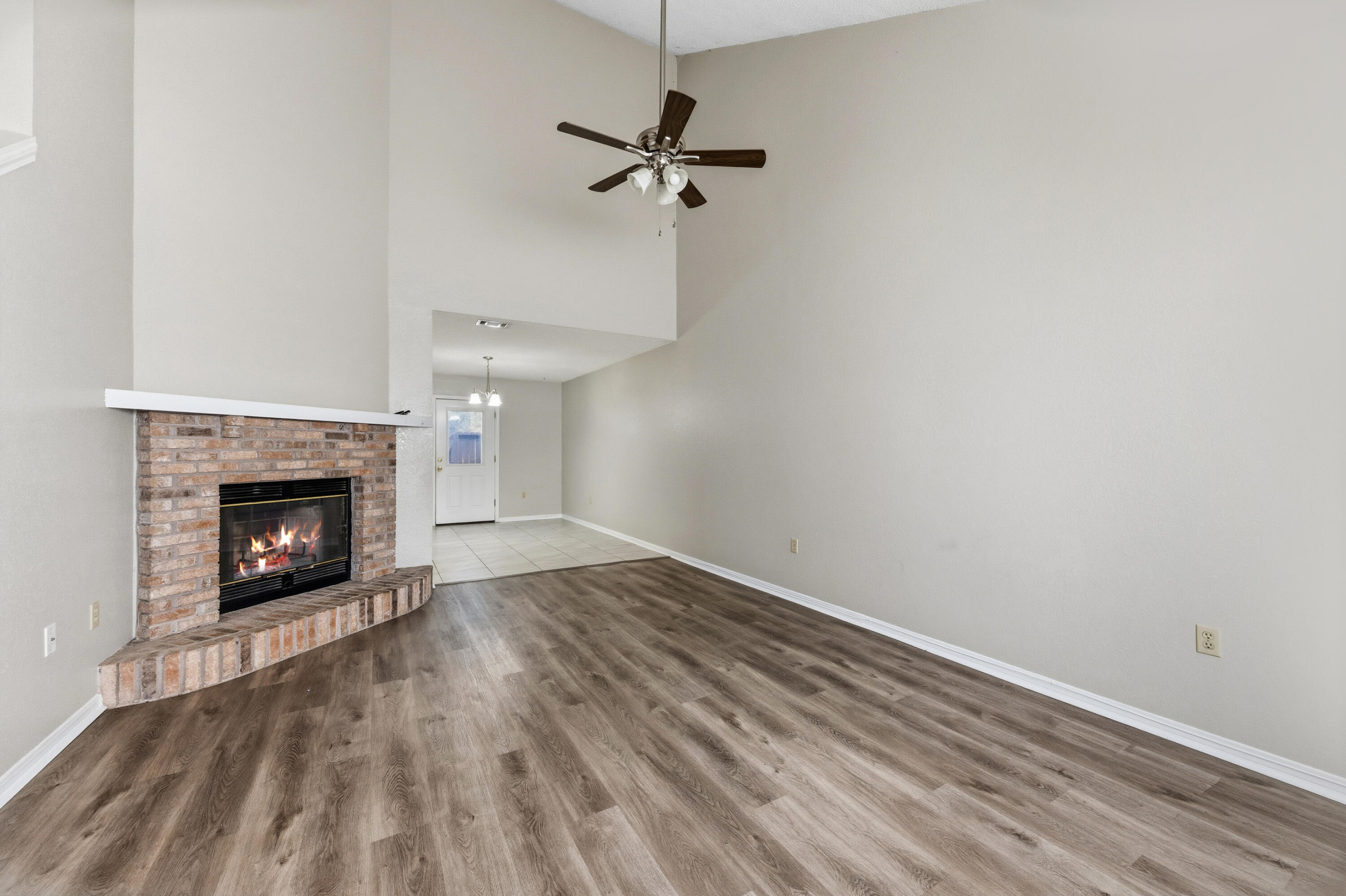 815 Valley Road Crestview, FL 32539 - Photo 3 of 40 a view of a room with a fireplace a ceiling fan and wooden floor