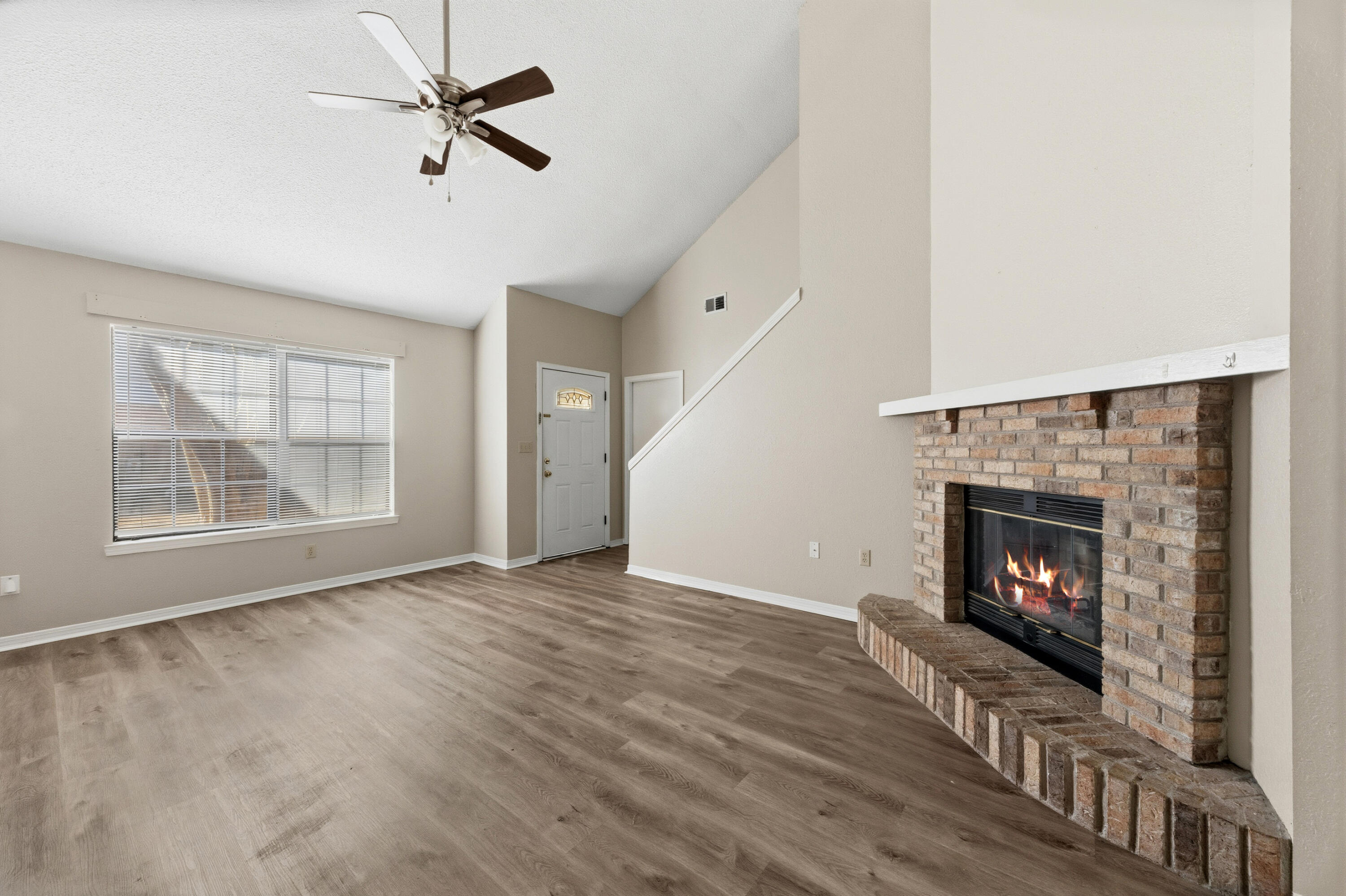 815 Valley Road Crestview, FL 32539 - Photo 5 of 40 a view of an empty room with wooden floor fireplace and a window