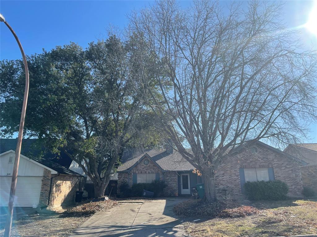 a wooden bench sitting in front of a house