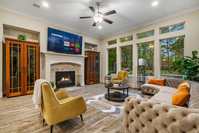 a living room with furniture fireplace and a large window