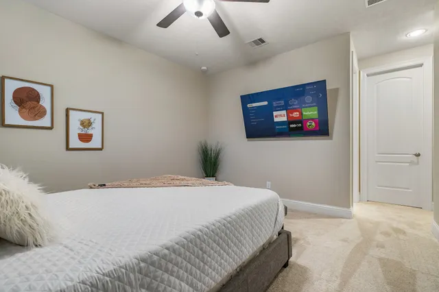 a bedroom with a bed and a flat screen tv