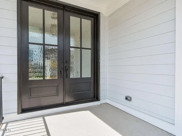 an empty room with wooden floor and ceiling fan