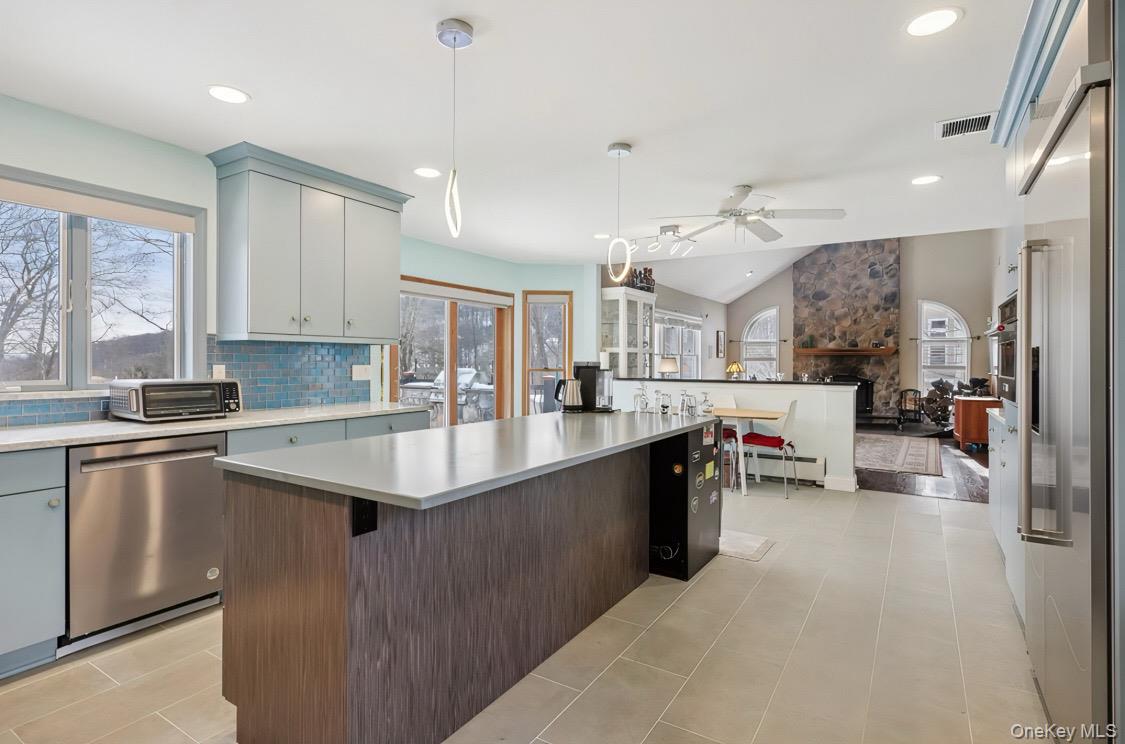 7 Gooler Court Stony Point, NY 10980 - Photo 13 of 35 Kitchen with backsplash, stainless steel appliances, hanging light fixtures, a center island, and a fireplace