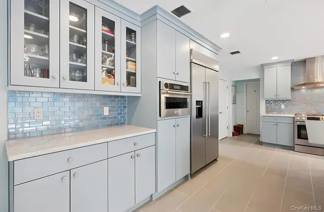 a kitchen with stainless steel appliances a refrigerator sink and cabinets