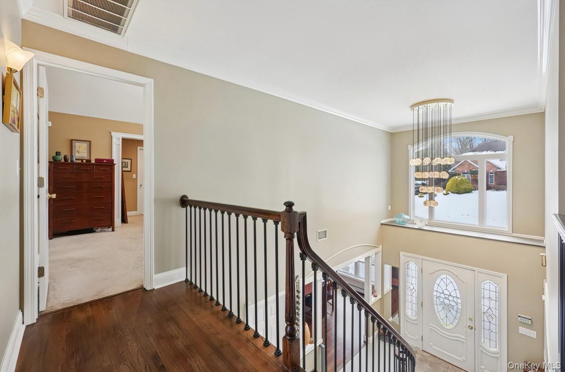 7 Gooler Court Stony Point, NY 10980 - Photo 19 of 35 Hall featuring an upstairs landing, ornamental molding, and dark wood finished floors