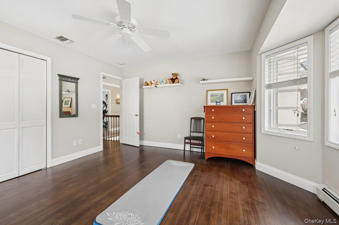7 Gooler Court Stony Point, NY 10980 - Photo 25 of 35 Living area featuring baseboard heating, dark wood finished floors, and ceiling fan
