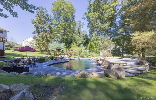 a view of swimming pool with outdoor seating and plants