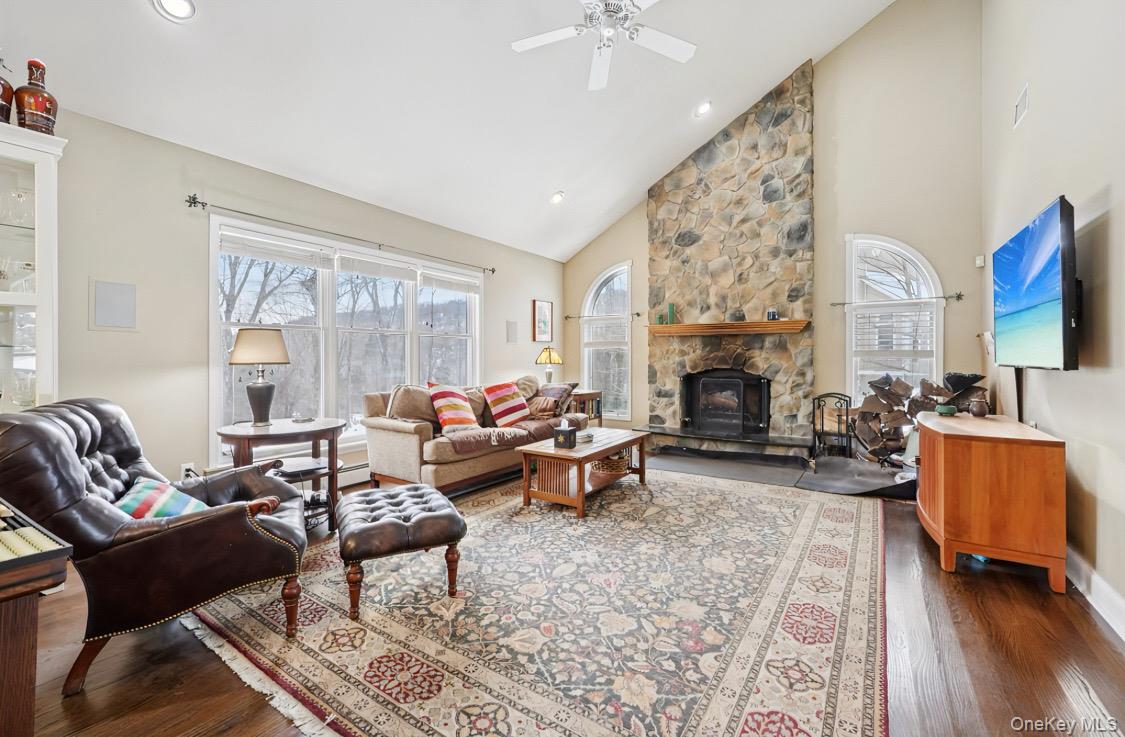 7 Gooler Court Stony Point, NY 10980 - Photo 7 of 35 Living area with high vaulted ceiling, a stone fireplace, wood-type flooring, recessed lighting, and ceiling fan