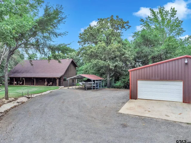a view of a house with a yard and garage