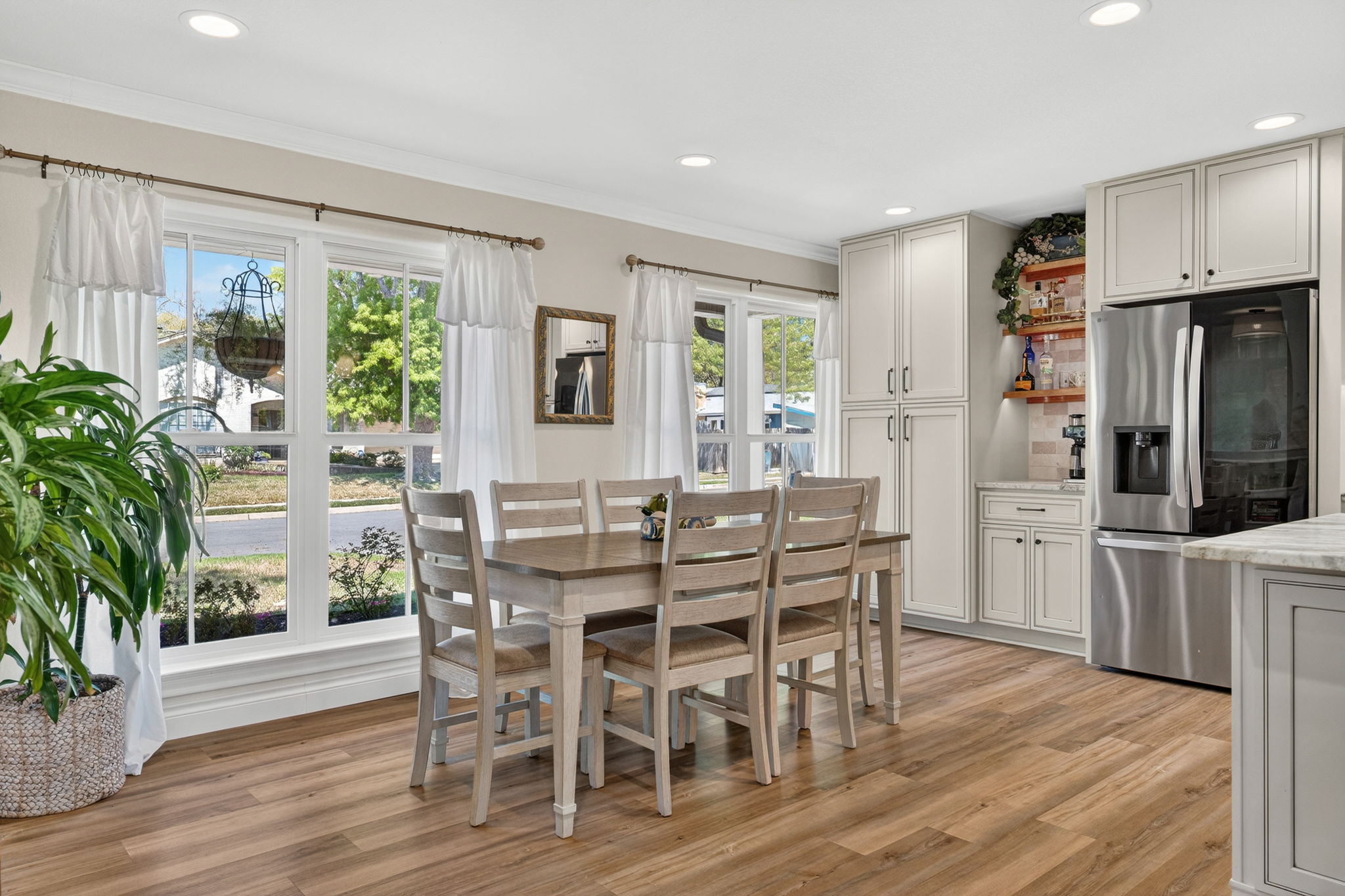 8611 Winding Walk Austin, TX 78757 - Photo 13 of 29 A dedicated beverage station or coffee bar sits adjacent to the dining area, complete with open shelving, making this the ultimate home for hosting Sunday brunch.