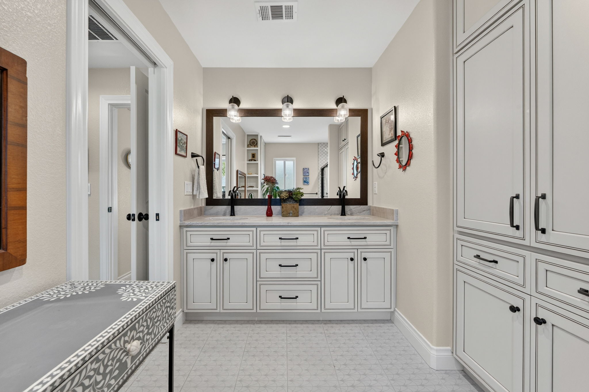 8611 Winding Walk Austin, TX 78757 - Photo 16 of 29 The ensuite bathroom is updated with a double vanity with a quartzite countertop and plenty of built-in linen storage.