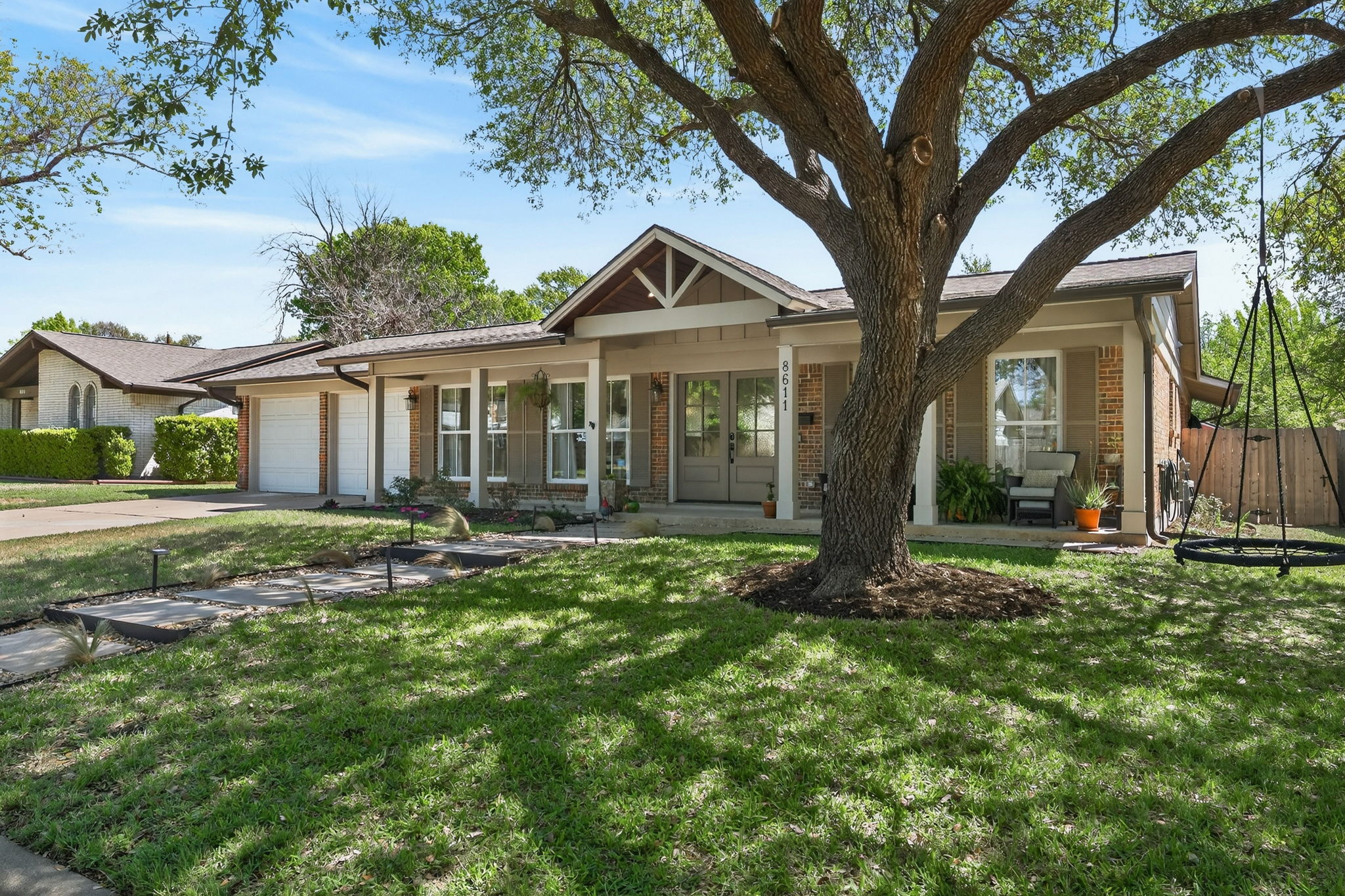 8611 Winding Walk Austin, TX 78757 - Photo 2 of 29 Framed by a magnificent, sprawling live oak, this home offers the quintessential North Austin vibe.