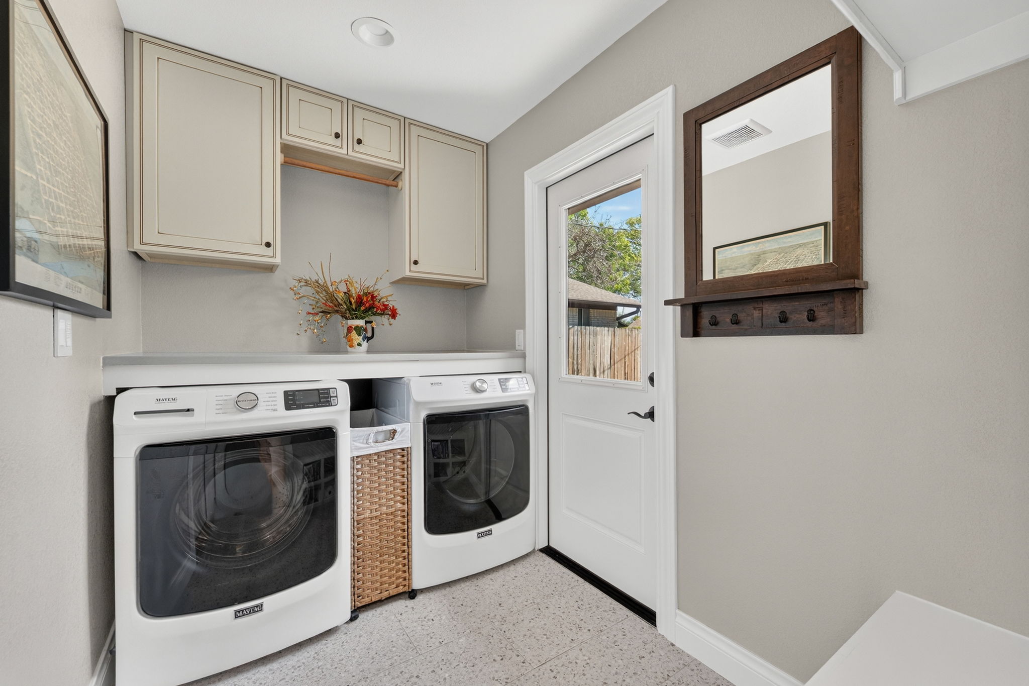 8611 Winding Walk Austin, TX 78757 - Photo 24 of 29 Even the chores look better here. This functional space features a practical folding counter, accented by custom cabinetry and easy access to the backyard.