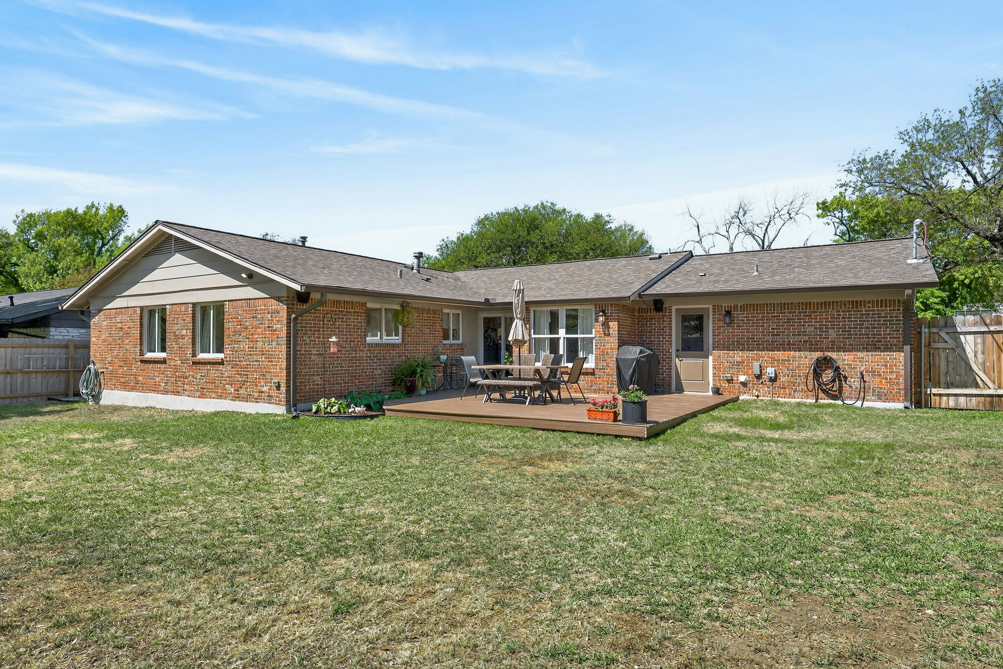 8611 Winding Walk Austin, TX 78757 - Photo 26 of 29 This expansive, fully-fenced lot has a lush lawn offering plenty of room to run.