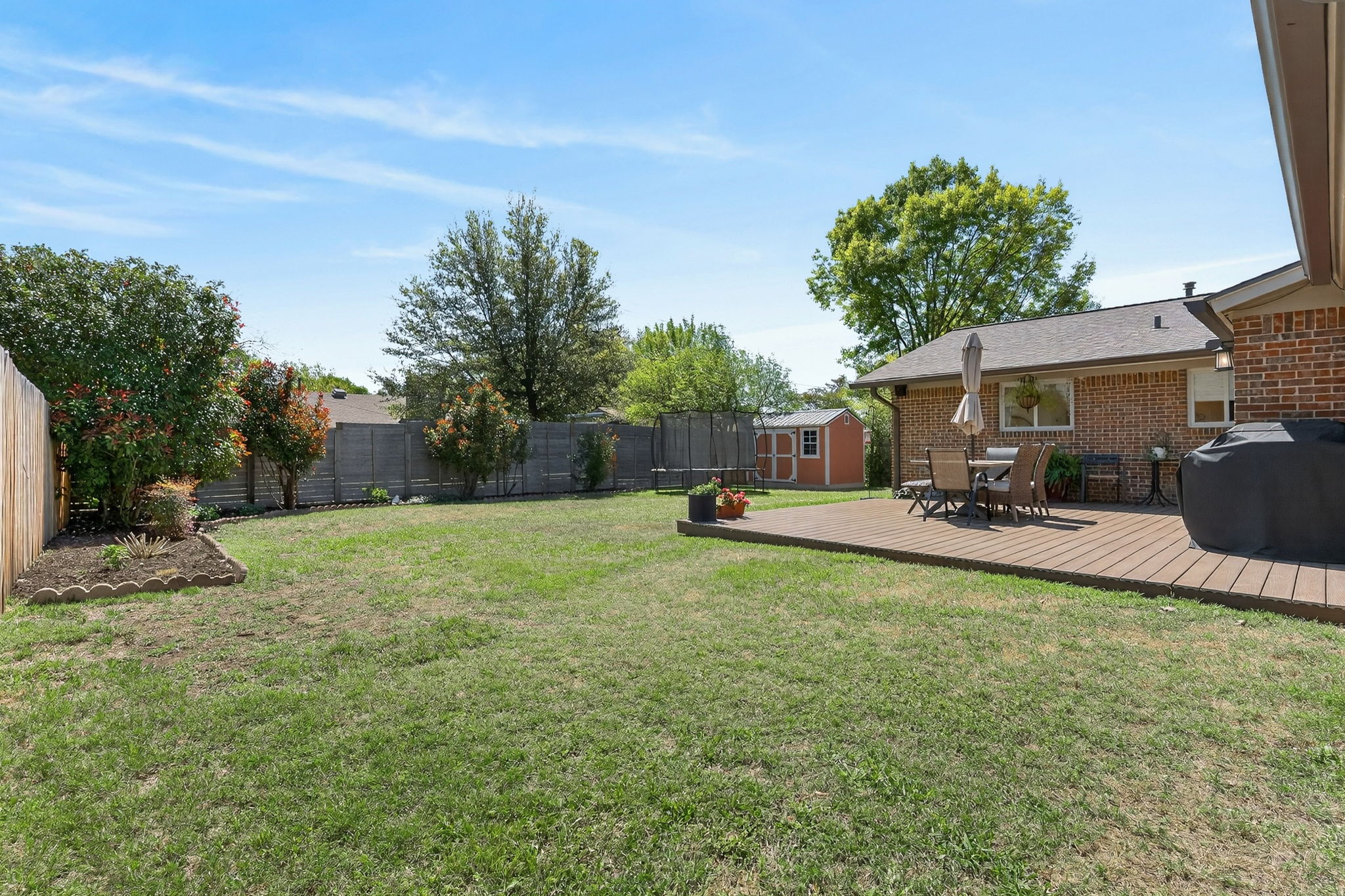 8611 Winding Walk Austin, TX 78757 - Photo 27 of 29 The yard is large enough to comfortably host a trampoline and a detached storage shed without feeling crowded. Mature trees along the perimeter offer a sense of privacy and that signature Austin greenery.