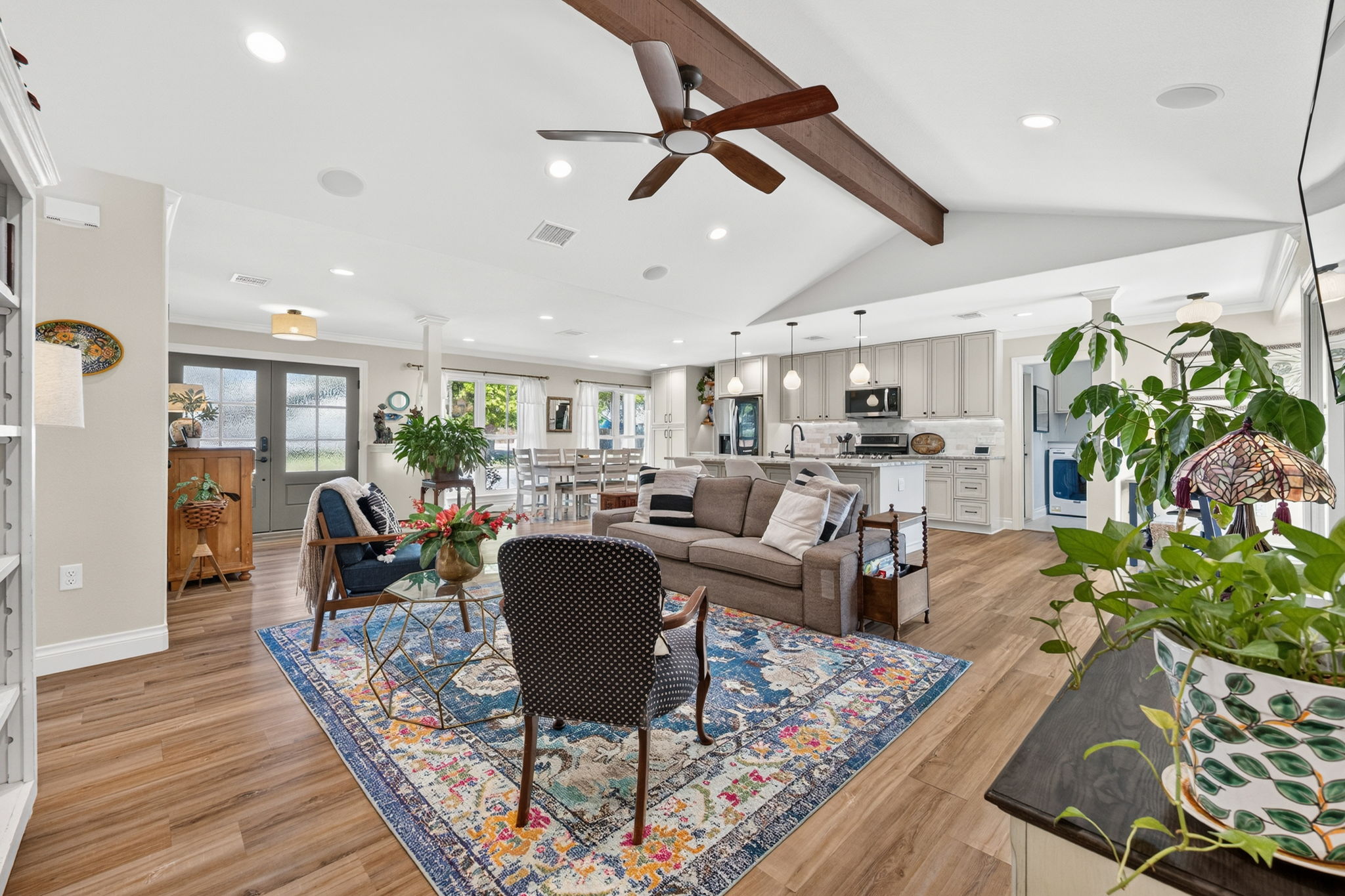 8611 Winding Walk Austin, TX 78757 - Photo 4 of 29 Experience true open-concept living. This breathtaking Great Room unites the kitchen, dining, and living areas under a vaulted ceiling anchored by a rustic wood beam.