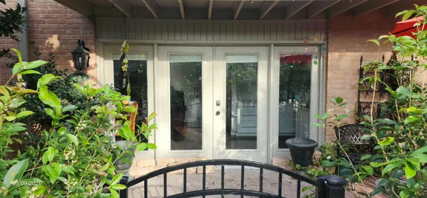 a couple of potted plants in front of door