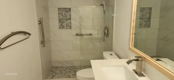 a view of a pathway with a tree in the background