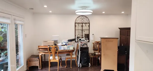 a hallway with painting and a potted plant