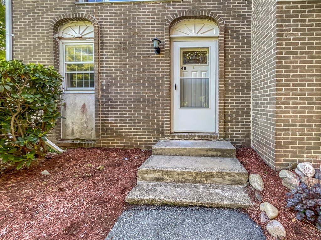 15 Cannongate Road, Unit 48 Tyngsborough, MA 01879 - Photo 1 of 25 a view of a brick house with many windows