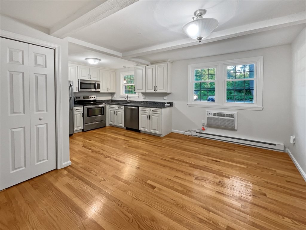 15 Cannongate Road, Unit 48 Tyngsborough, MA 01879 - Photo 11 of 25 a kitchen with stainless steel appliances kitchen island granite countertop a stove a sink and a refrigerator