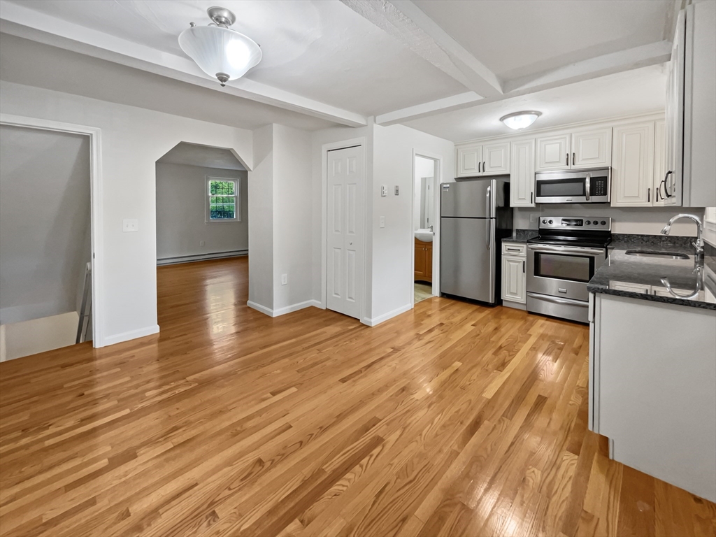 15 Cannongate Road, Unit 48 Tyngsborough, MA 01879 - Photo 12 of 25 a kitchen with stainless steel appliances a refrigerator and a stove top oven