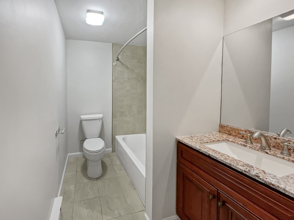 15 Cannongate Road, Unit 48 Tyngsborough, MA 01879 - Photo 17 of 25 a bathroom with a granite countertop sink toilet and shower