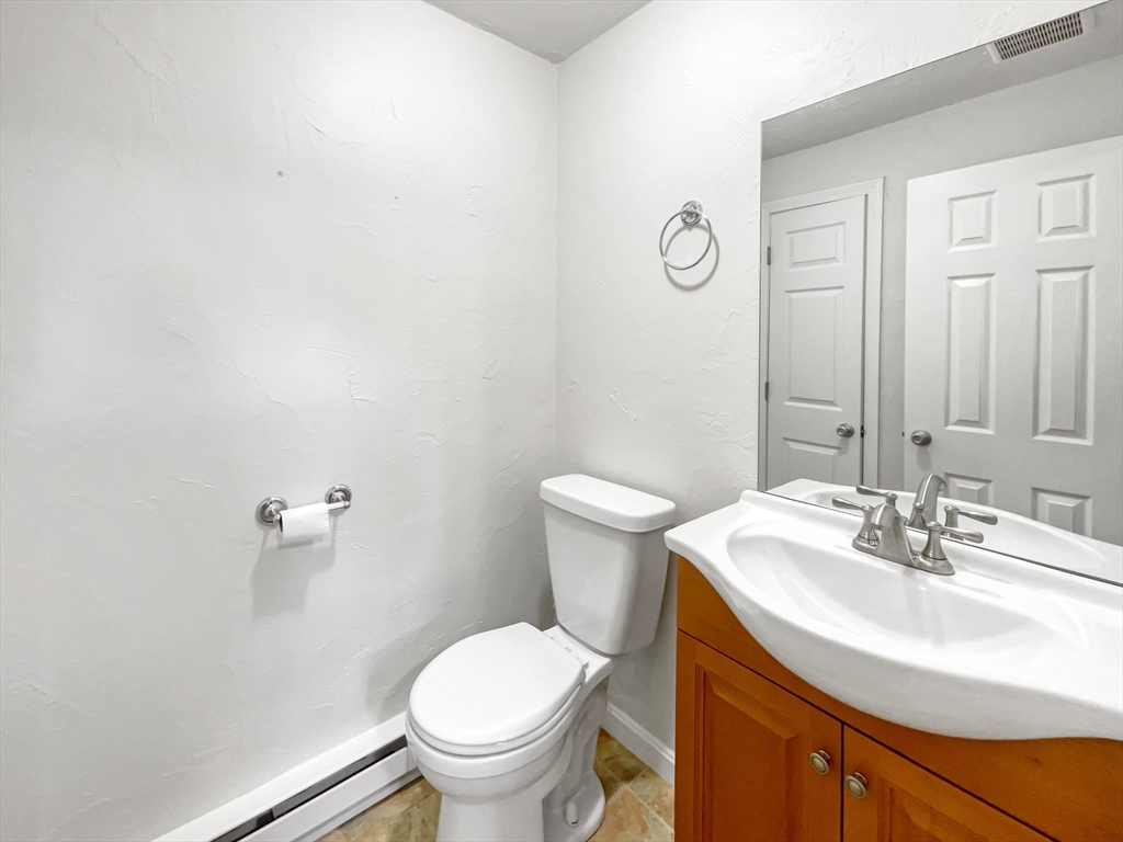 15 Cannongate Road, Unit 48 Tyngsborough, MA 01879 - Photo 19 of 25 a bathroom with a sink toilet and a mirror