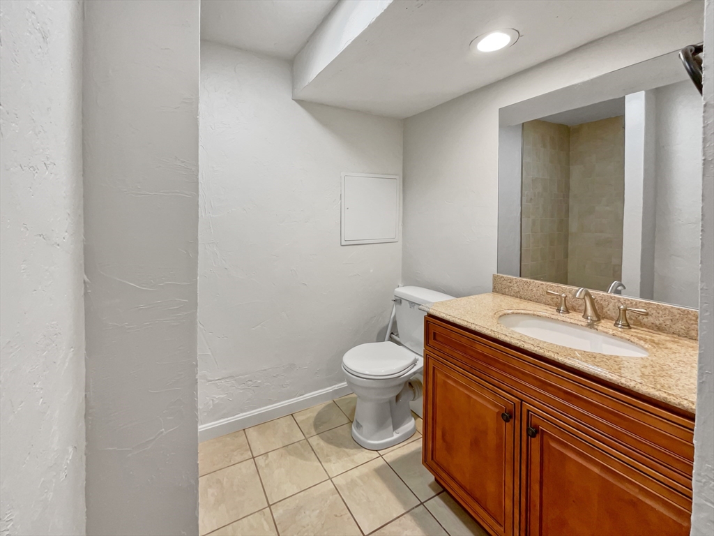 15 Cannongate Road, Unit 48 Tyngsborough, MA 01879 - Photo 21 of 25 a bathroom with a granite countertop toilet and a sink