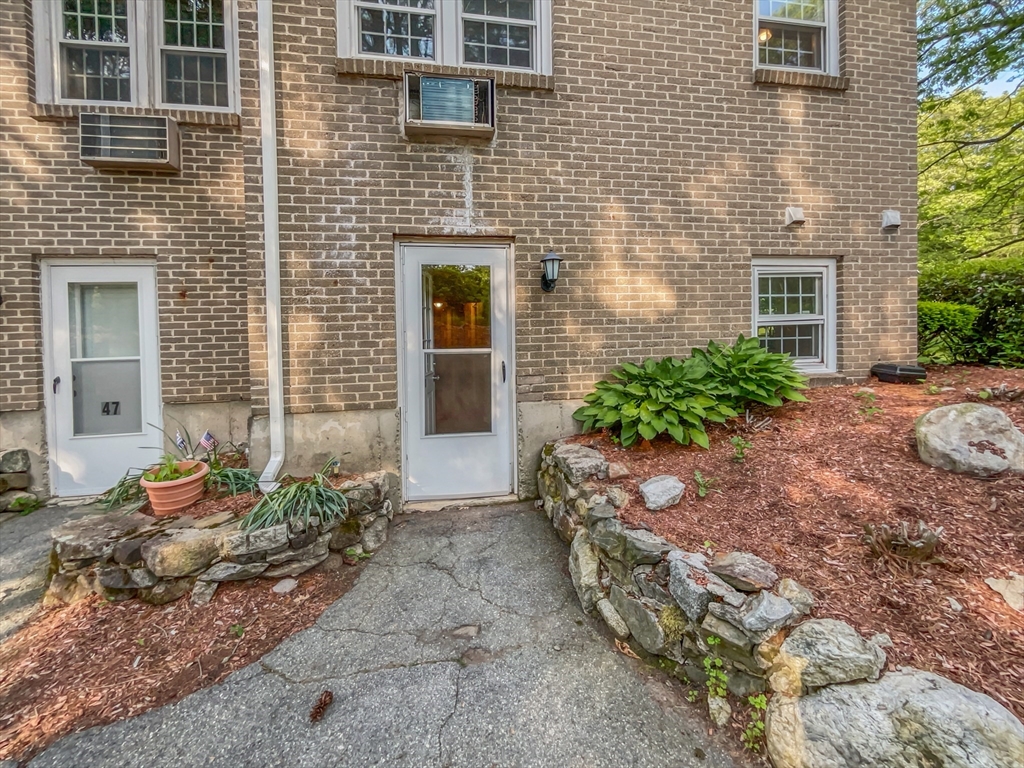 15 Cannongate Road, Unit 48 Tyngsborough, MA 01879 - Photo 25 of 25 a front view of a house with a yard