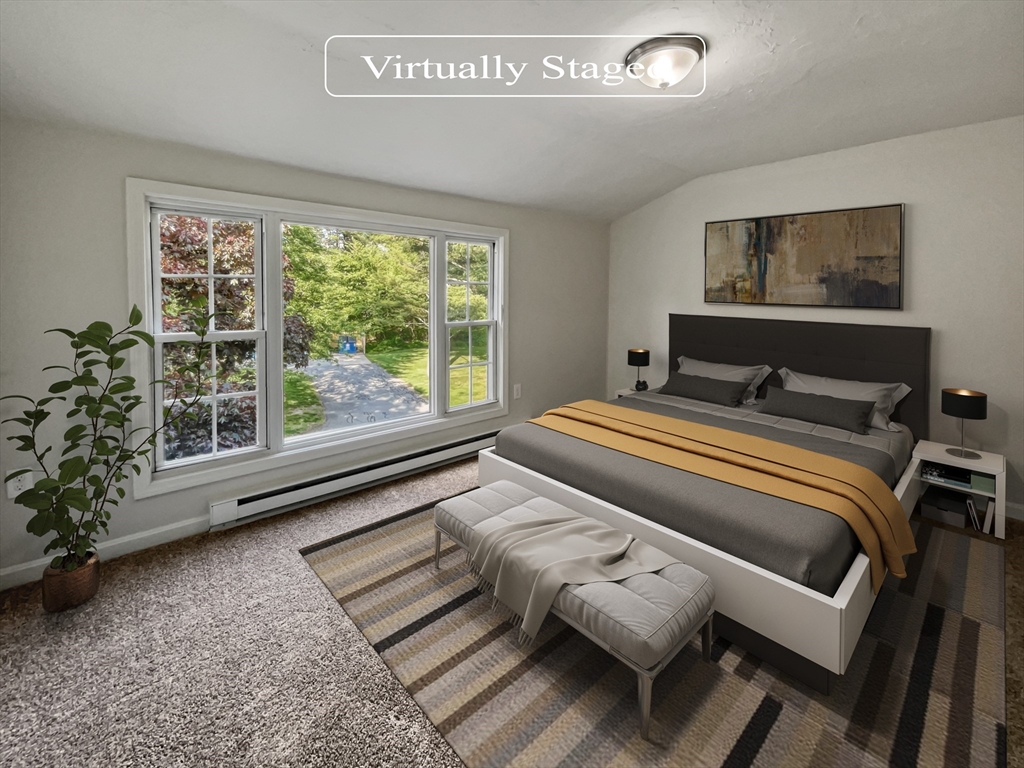 15 Cannongate Road, Unit 48 Tyngsborough, MA 01879 - Photo 4 of 25 a bedroom with a bed and glass window