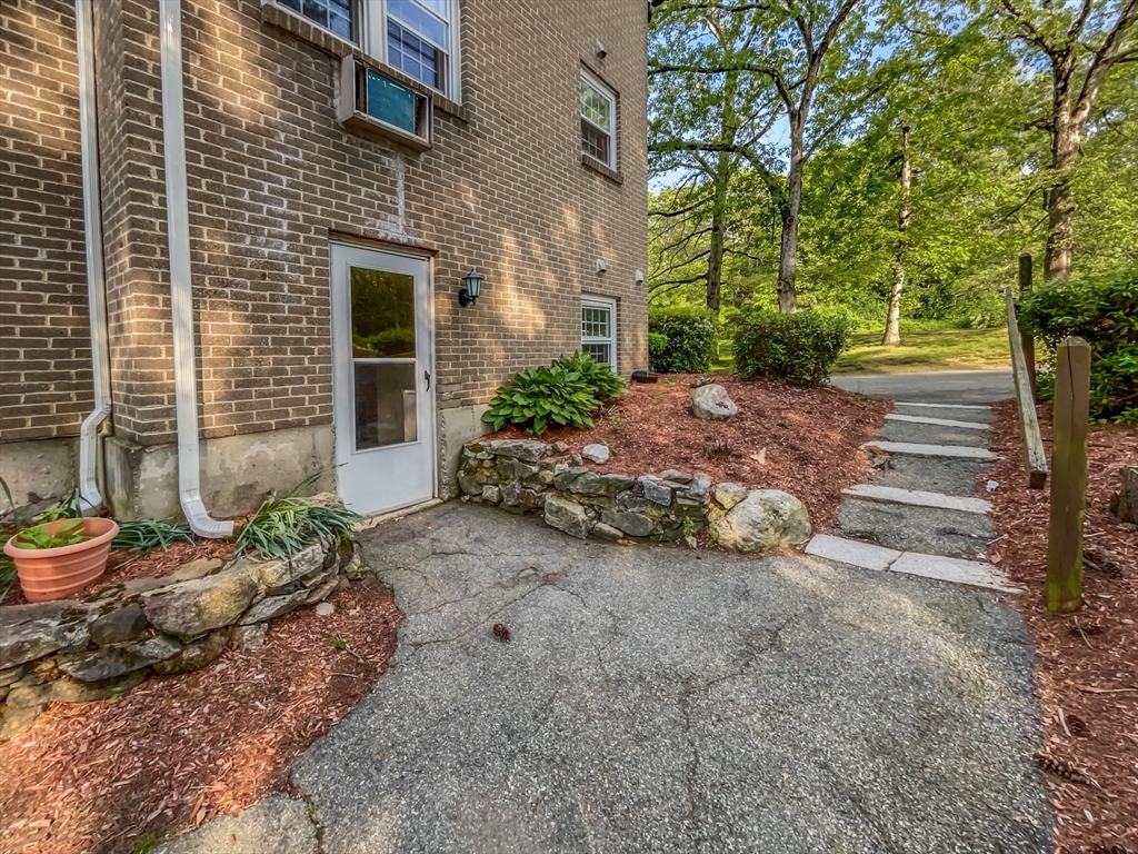15 Cannongate Road, Unit 48 Tyngsborough, MA 01879 - Photo 7 of 25 a view of a backyard with table and chairs and potted plants